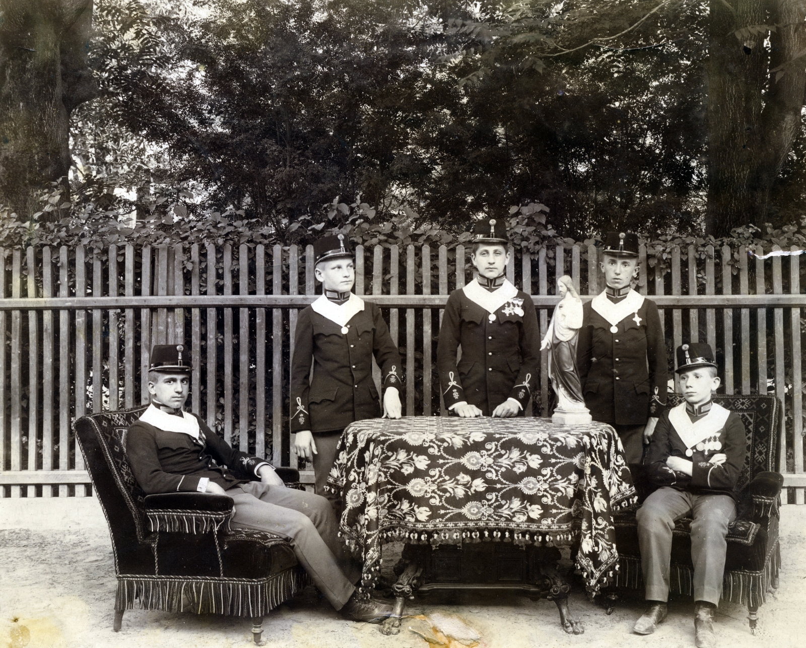 Hungary, Kalocsa, az Érseki Főgimnázium udvara., 1908, Jezsuita Levéltár, tableau, kids, lath fence, cadet, Jesus Christ-portrayal, arms crossed over the chest, Fortepan #100146