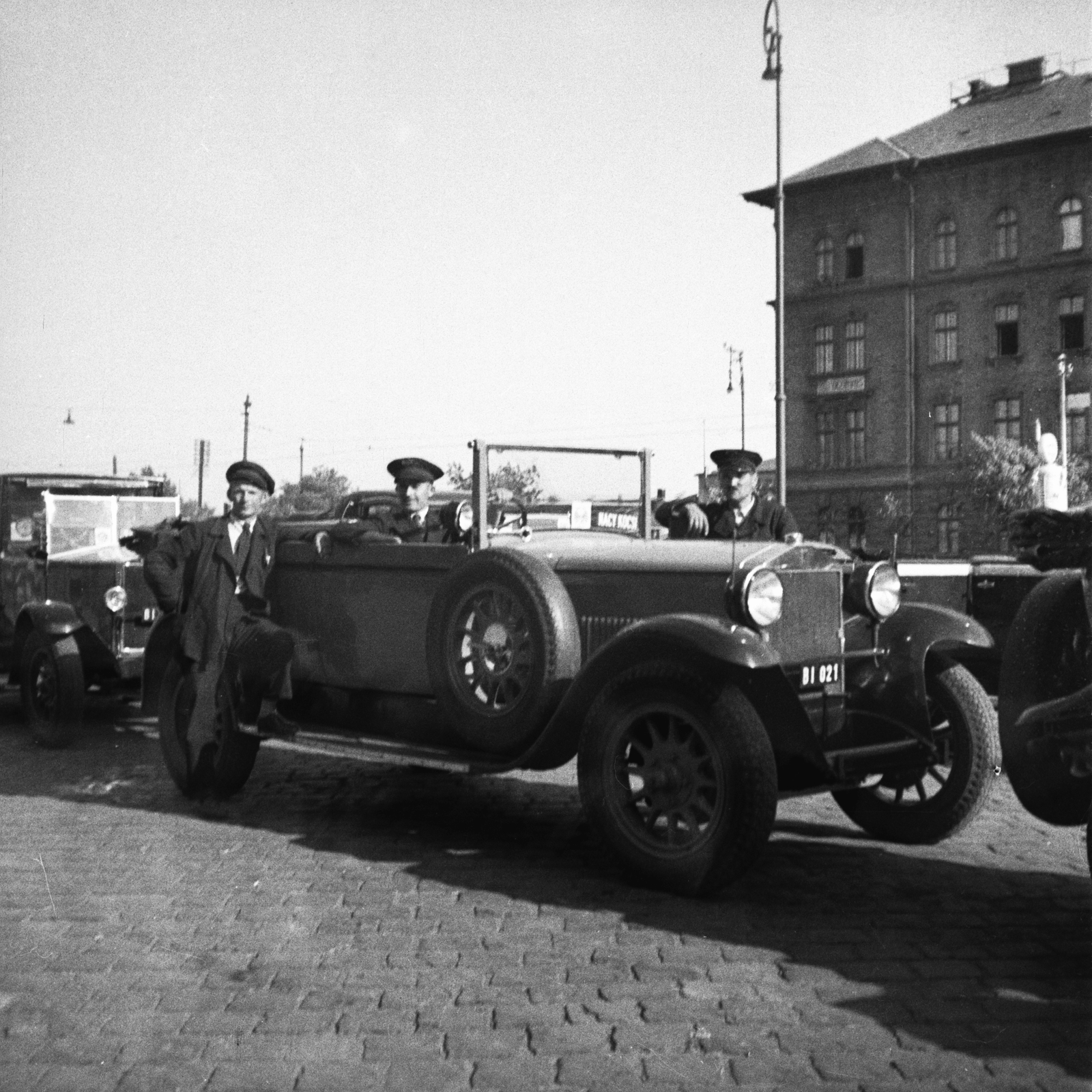Hungary, Budapest VIII., Kerepesi út, a Keleti pályaudvar érkezési oldalánál. Jobbra a MÁV irodaházak sarka., 1932, Antal Dániel, taxicab, number plate, spare wheel, Budapest, building, chauffeur, Fortepan #100470