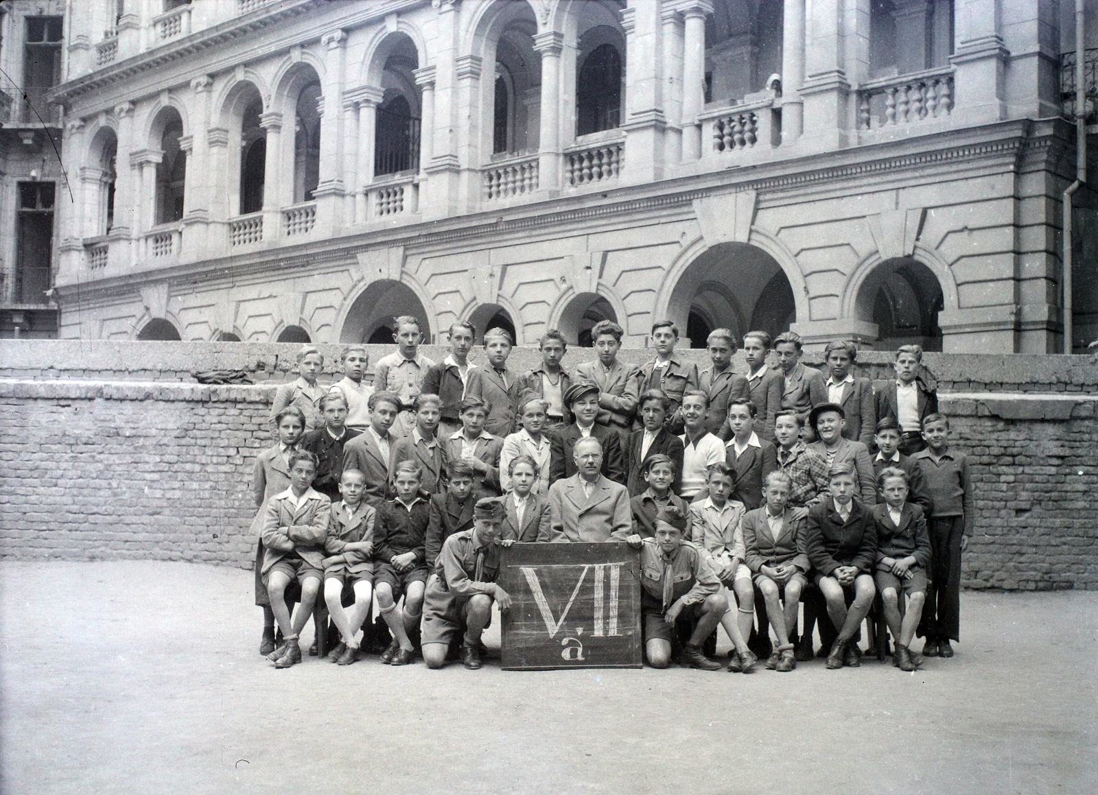 Hungary, Budapest VI., Felső erdősori Általános iskola (később Erkel Ferenc Általános Iskola) udvara, csoportkép egy hetedikes osztályról. Háttérben az Andrássy út 83–85. számú ház udvari homlokzata., 1948, Hámori Gyula, Budapest, class photo, Fortepan #105238