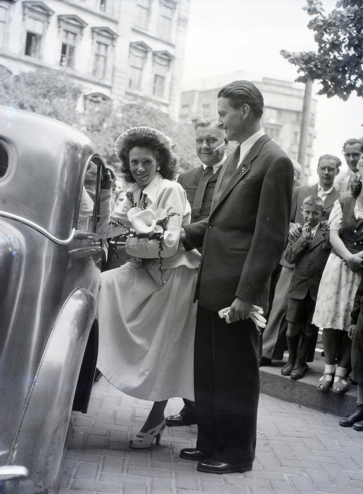 Hungary, Budapest V.,Budapest VI., Szent István tér a Szent István-bazilika északi oldalánál, háttérben a Bajcsy-Zsilinszky út 18. és a 19., 1948, Hámori Gyula, Budapest, entering the car, Fortepan #105315