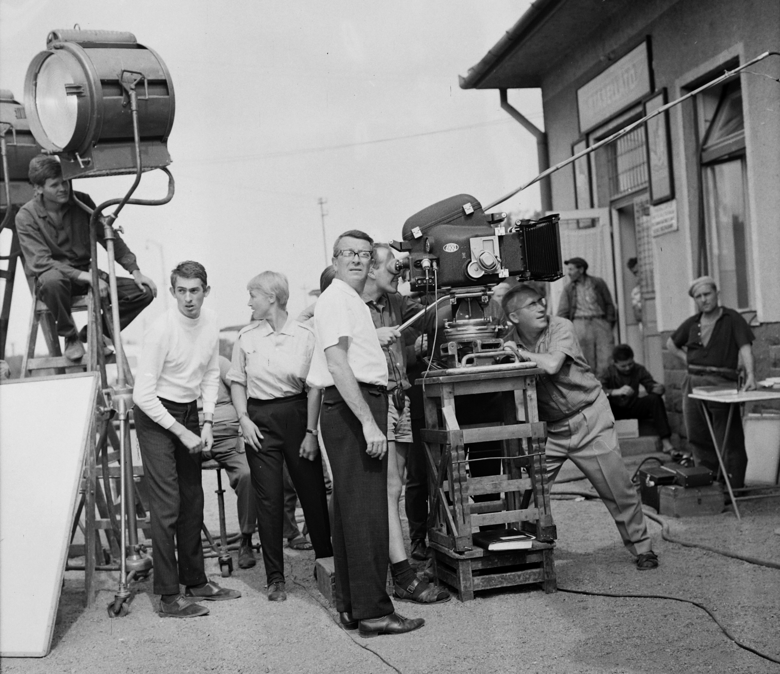 Hungary, Balatonvilágos, Balatonaliga, vasútállomás. A kamerától balra, szemüveggel Fábri Zoltán rendező, jobbra Illés György operatőr, a lámpa alatt fehér garbóban András Ferenc, a későbbi filmrendező, itt mint rendező-asszisztens az Utószezon című film forgatásán., 1966, Hunyady József, filming, movie camera, Fortepan #106425