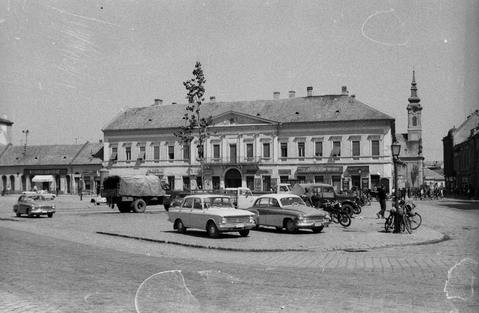 Magyarország, Baja, Szentháromság (Béke) tér, jobbra a Tóth Kálmán téren a Szent Péter és Pál apostolok templom. A felvétel az Aranysárkány című film forgatásakor készült., 1966, Hunyady József, Wartburg-márka, Wartburg 311/312, GAZ 69, Moszkvics 412, Fortepan #107300