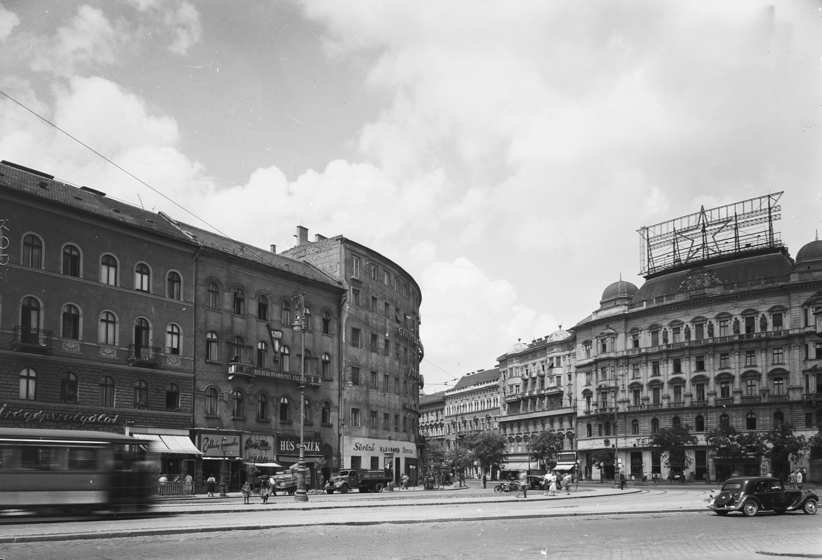 Hungary, Budapest V.,Budapest VI.,Budapest XIII., Nyugati (Marx) tér a Bajcsy-Zsilinszky út és a Szent István körút találkozásánál., 1953, UVATERV, socialism, candelabra, commercial vehicle, street view, cityscape, tram, architectural ornament, lamp post, butcher shop, Red Star, number plate, greengrocer, candy store, Budapest, Fortepan #10911