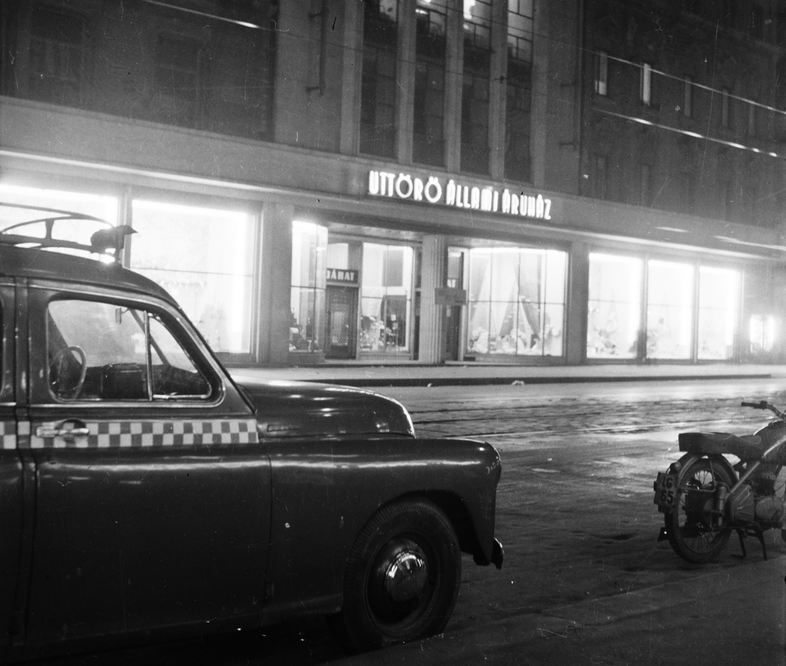 Hungary, Budapest V., Kossuth Lajos utca 9., Úttörő Áruház., 1957, Bauer Sándor, motorcycle, taxicab, night, M20 Pobeda, number plate, neon sign, Budapest, Fortepan #113001