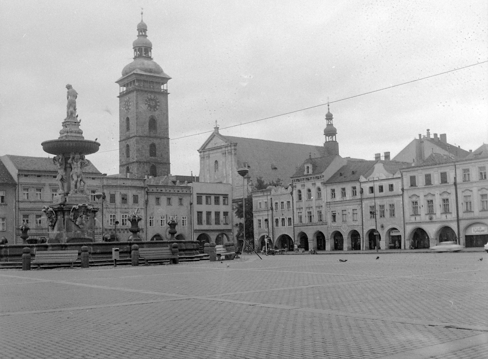 Czech Republik, České Budějovice, II. Přemysl Ottokár tér (Náměstí Přemysla Otakara II., ekkor Žižkovo náměstí) a Sámson szökőkúttal, háttérben a Fekete-torony és a Szent Miklós-katedrális., 1958, Gyöngyi, Czechoslovakia, church, fountain, sculpture, square, Baroque-style, cobblestones, Catholic Church, tower, archway, church clock, Cathedral, bell tower, Atlas-portrayal, National Heritage, Josef Dietrich-design, Zacharias Horn-design, Hans Spatz-design, Vincenc Vogarelli-design, Samson-portrayal, Fortepan #12762