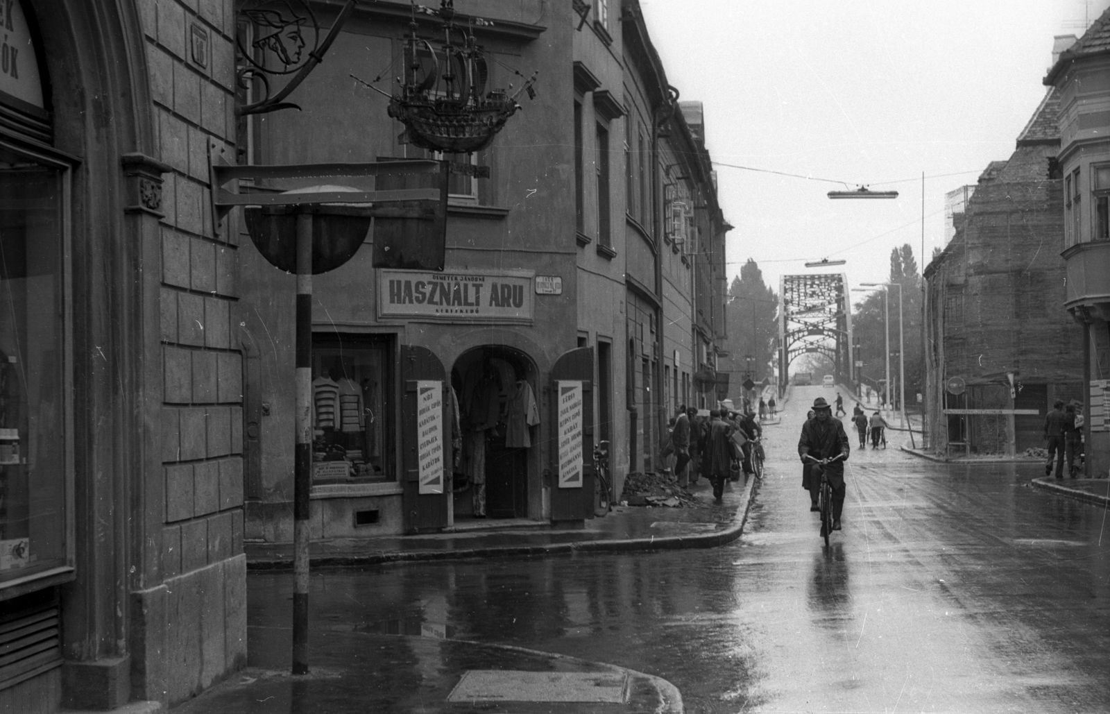 Magyarország, Győr, Jedlik Ányos utca a Dr. Kovács Pál utca sarkától a felállványozott Kreszta-ház és a Kossuth híd felé nézve. Előtérben fent az Aranyhajó Patika cégére., 1973, Vizsnyiczai Erzsébet, kerékpár, Fortepan #130744