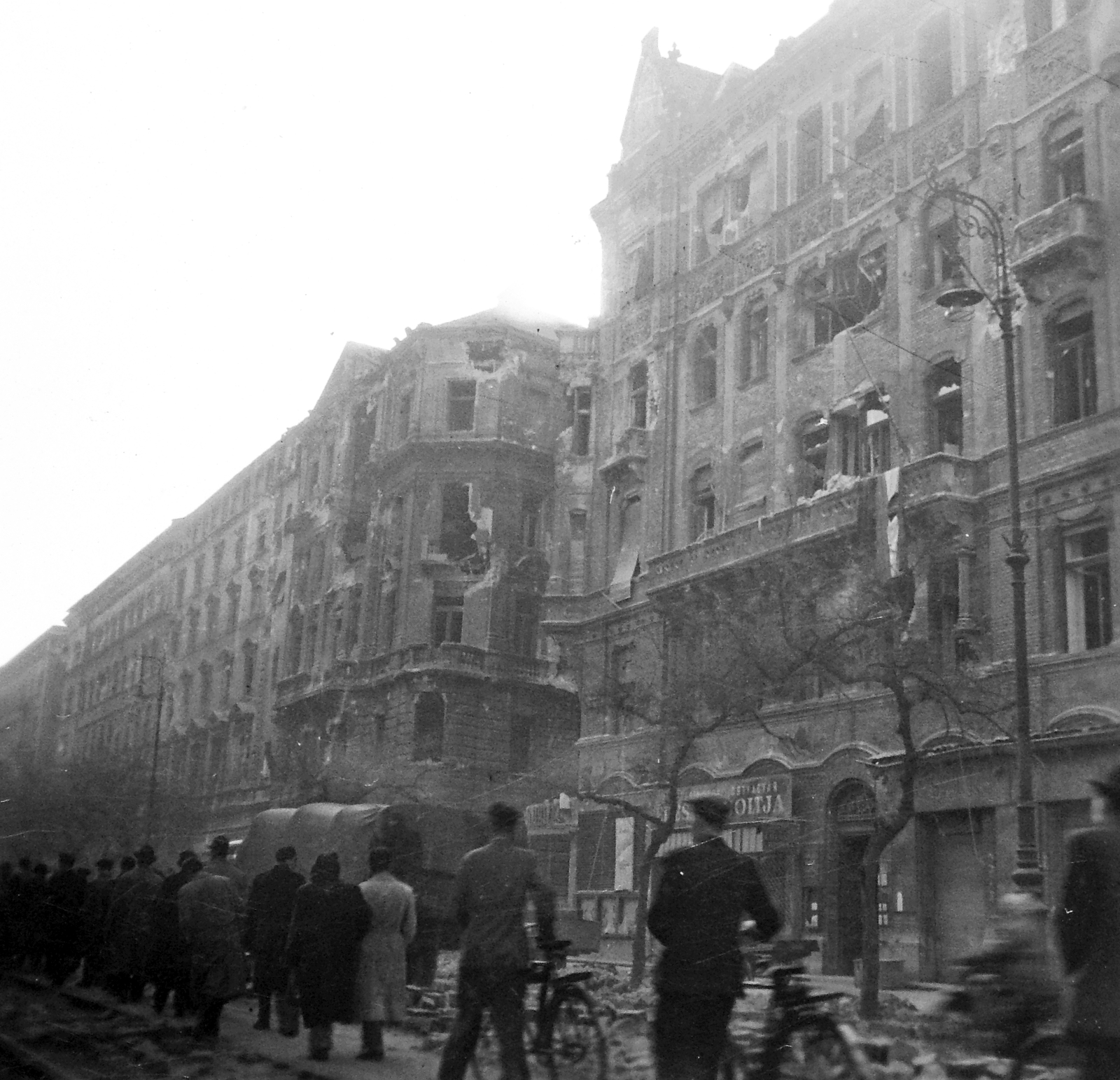 Hungary, Budapest VIII., József körút, szemben a Csepreghy utca sarka., 1956, Nagy József, bicycle, revolution, pedestrian, commercial vehicle, street view, damaged building, candy store, Budapest, Fortepan #13707