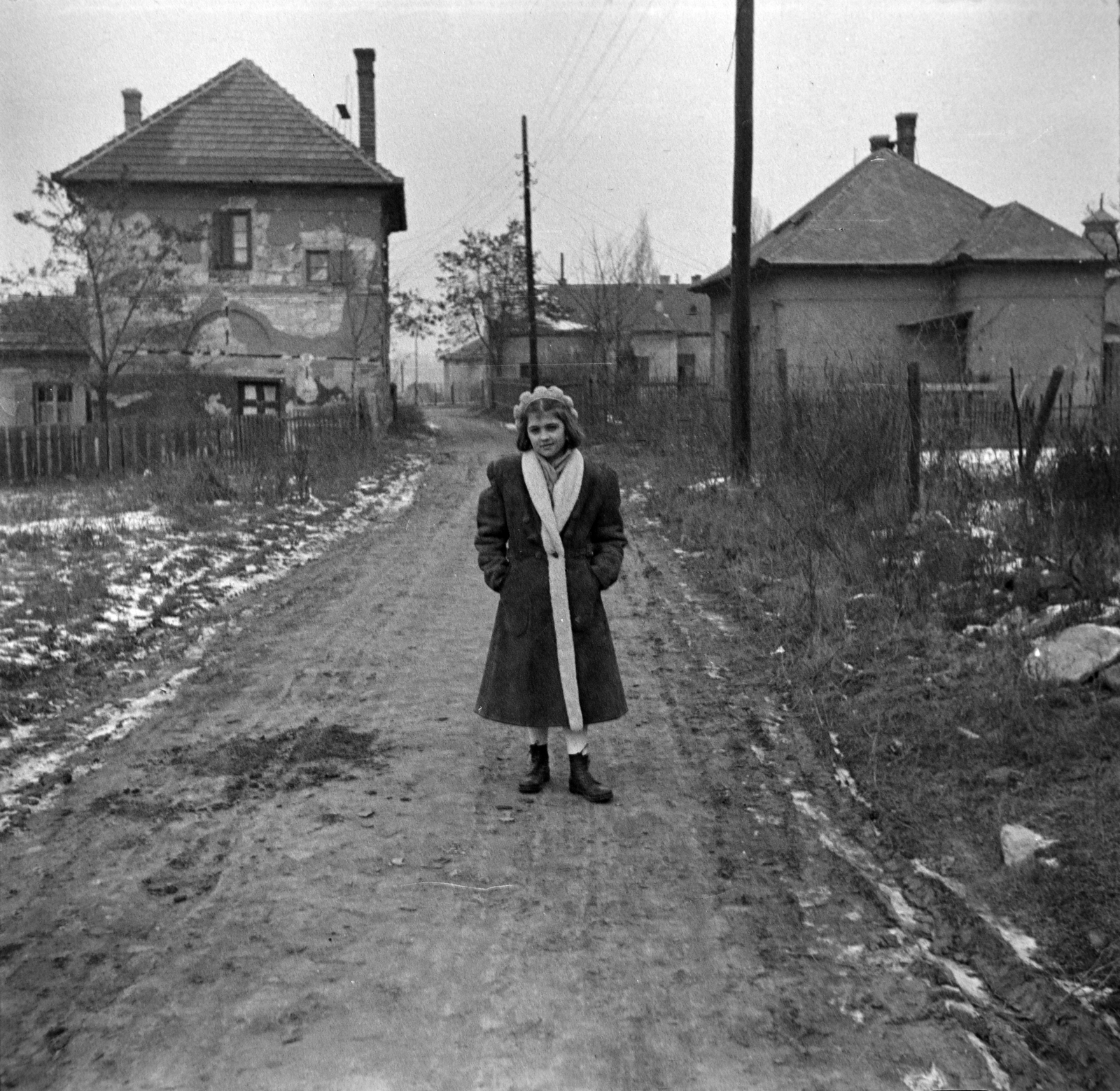 1952, Miklós Lajos, hands in pockets, street view, photo aspect ratio: square, lady, dirt road, winter coat, cap, boots, Fortepan #140675