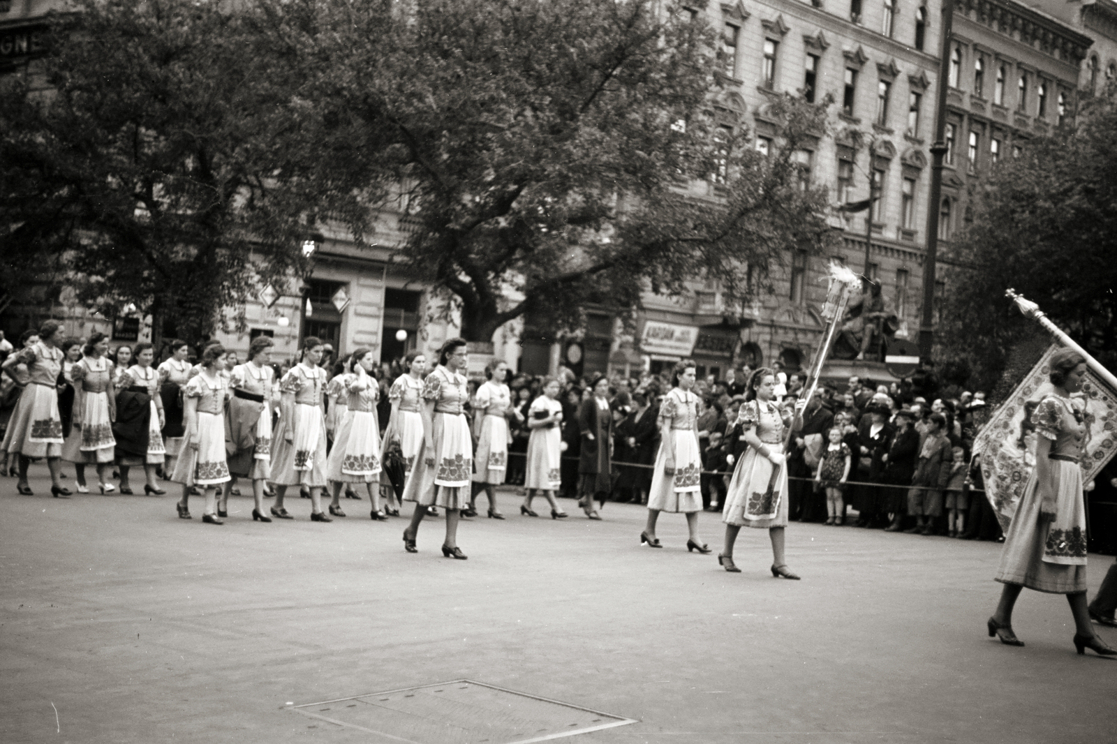 Hungary, Budapest VI., felvonulók az Andrássy úton, háttérben a Jókai téren Jókai Mór szobra (Stróbl Alajos, 1921.)., 1940, Chuckyeager tumblr, flag, march, Budapest, Fortepan #143434