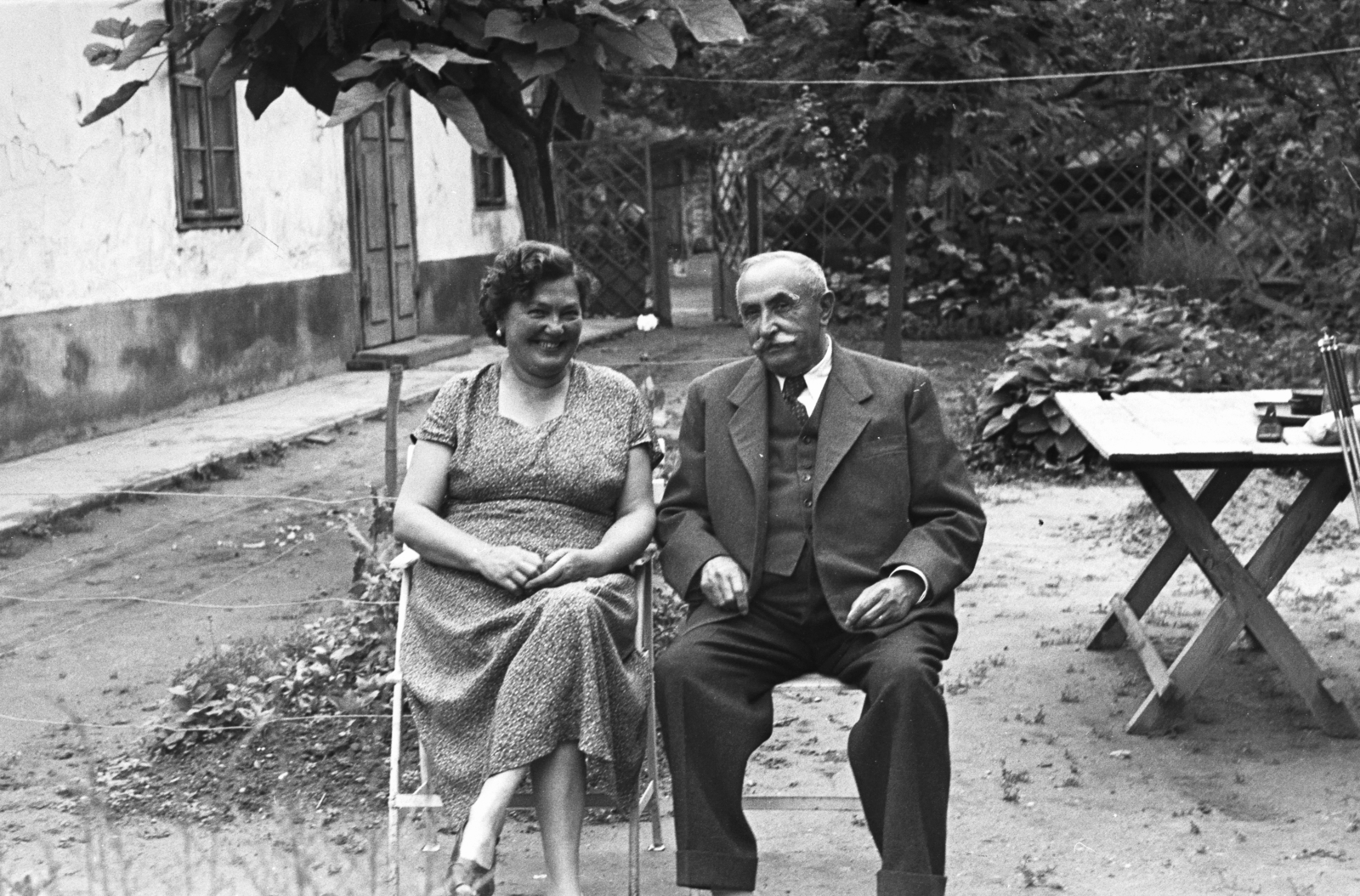 1955, Chuckyeager tumblr, summer dresses, old person, smile, vest, tie, suit, lady, double portrait, yard, Fortepan #175435