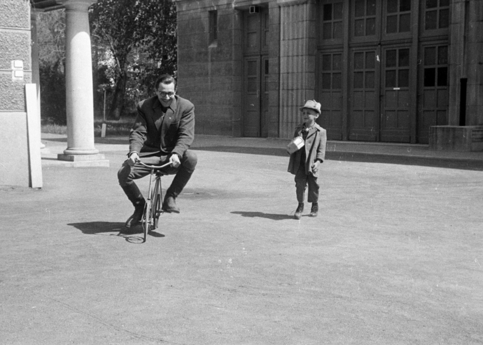 Magyarország, Budapest II., a Hunnia Filmgyár pasaréti telepének udvara, a műtermek előtt., 1952, Bojár Sándor, Budapest, tréfálkozás, kisfiú, kerékpár, mutatvány, Fortepan #179638
