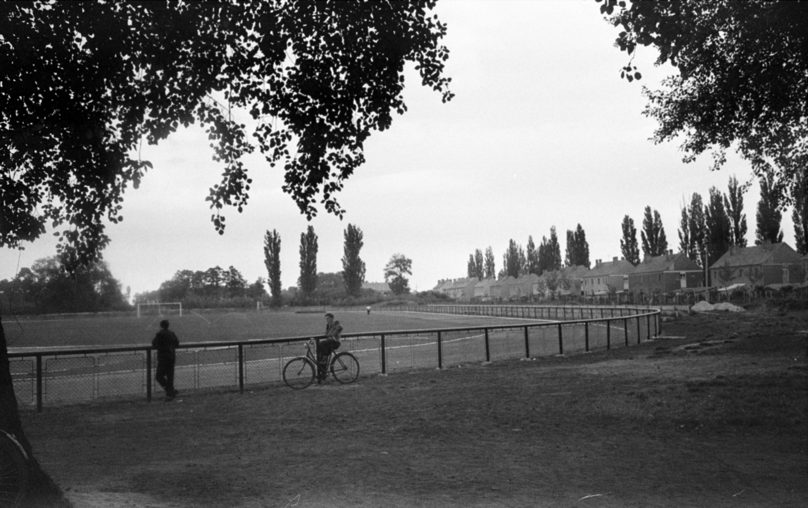 Hungary, Pápa, a Várkert utcai sportpálya (később a Perutz stadion épült fel a helyén), jobbra a Gróf (Bajcsy-Zsilinszky) út épületeinek hátsó frontja., 1968, Bojár Sándor, bicycle, Fortepan #179988