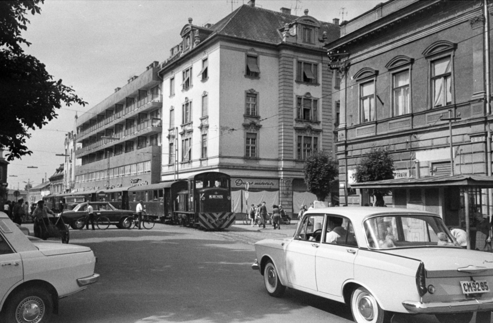 Hungary, Nyíregyháza, Kossuth tér, balra a Zrínyi Ilona utca, jobbra a Bethlen Gábor utca torkolata. Az NyVKV (Nyíregyházavidéki Kisvasutak) szerelvénye a villamossal közös pályaszakaszon., 1968, Bojár Sándor, MÁV MK48 series, diesel locomotive, narrow-gauge railway, Rába-brand, Nyírvidék Narrow Gauge Train-organisation, Fortepan #180009