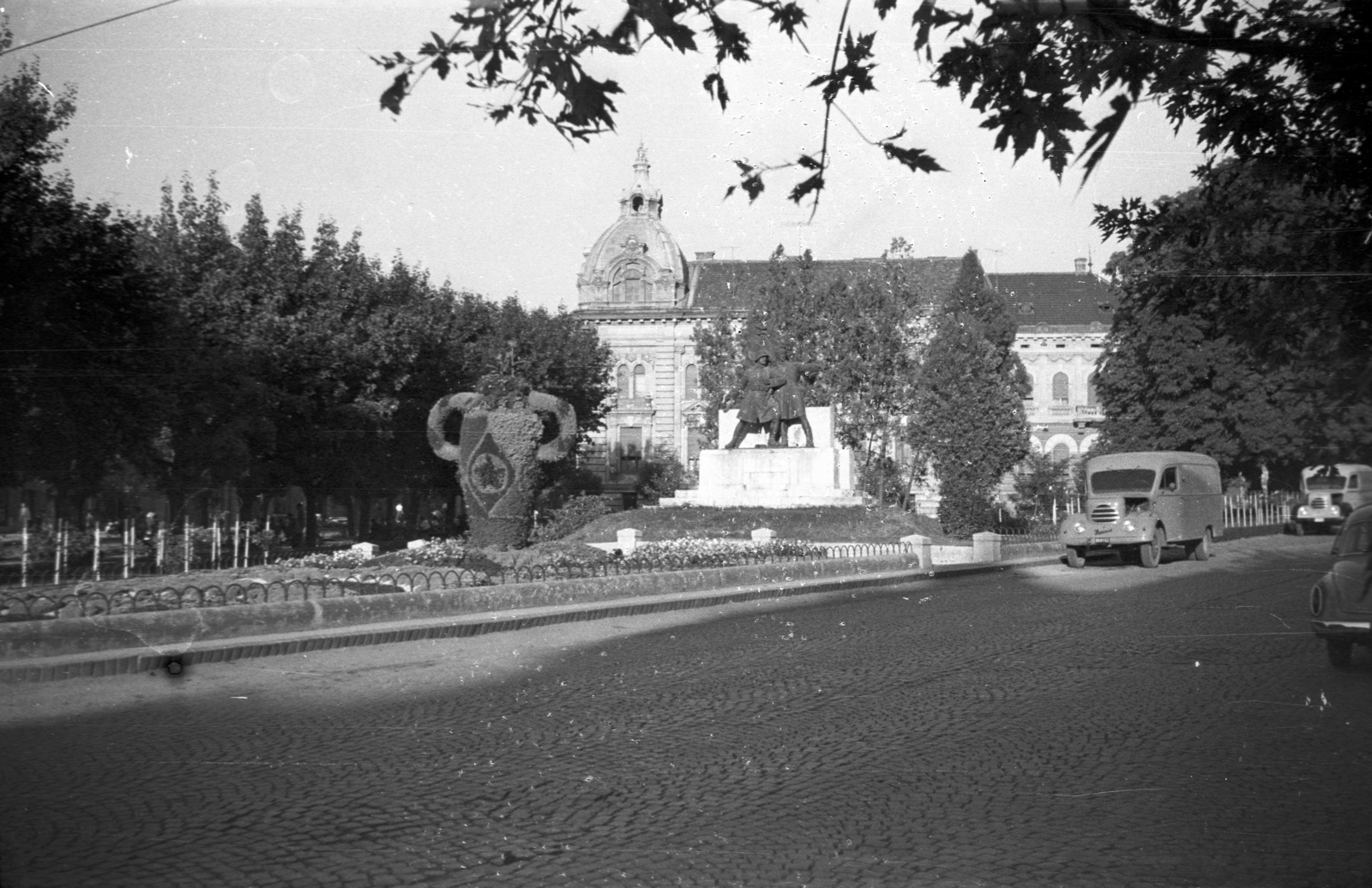 Hungary, Nagykanizsa, Deák Ferenc tér, szemben a 48. gyalogezred emlékműve / Petőfi-szobor (Kisfaludi Strobl Zsigmond, 1934.), mögötte a Bankpalota épülete., 1960, Kende János, sculpture, Red Star, decoration, bush, commercial vehicle, Fortepan #185351