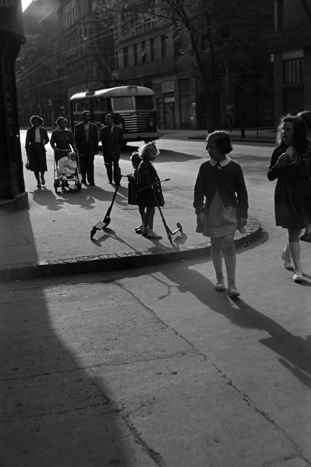 Hungary, Budapest VIII., Baross utca, a mára megszűnt Beniczky Lajos utcánál. Szemben a trolibusz mögött a Vasas köz - Szűz utca közötti ház látszik., 1954, Kriss Géza, Budapest, kids, baby carriage, scooter, pavement, Fortepan #191794