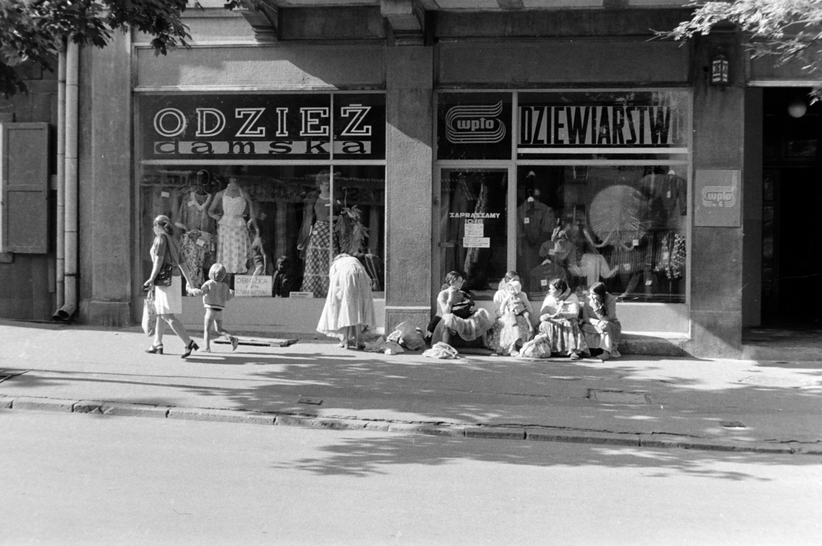 Poland,Tatry Wysokie, Zakopane, ulica Krupówki 36., 1970, Borbély Mihály, Fashion store, gypsy, sitting on the ground, Polish sign, store display, Fortepan #199823
