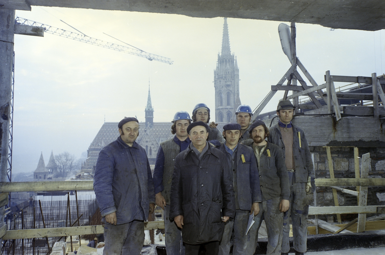 Magyarország, budai Vár, Budapest I., a Hilton szálló építkezése az egykori egykori jezsuita kollégium és rendház helyén. Háttérben a Mátyás-templom., 1975, FŐFOTÓ, színes, daru, munkás, Budapest, zsalu, Fortepan #206816