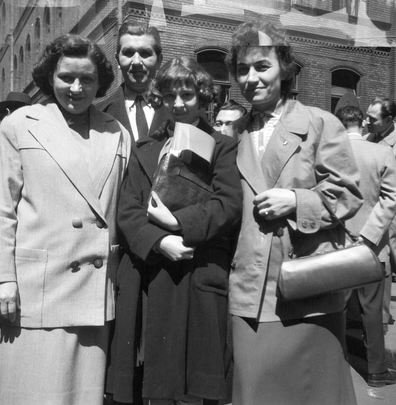 Hungary, Budapest VII., a felvétel a Kertész utca - Wesselényi utca kereszteződésében készült. A május 1-i felvonulás résztvevői mögött az egykori izraelita polgári leányiskola (később Wesselényi Utcai Bölcsőde, Óvoda, Általános Iskola, Gimnázium és Szakiskola) épülete., 1959, Szlávy Adrienne, Budapest, family, handbag, Fortepan #211798