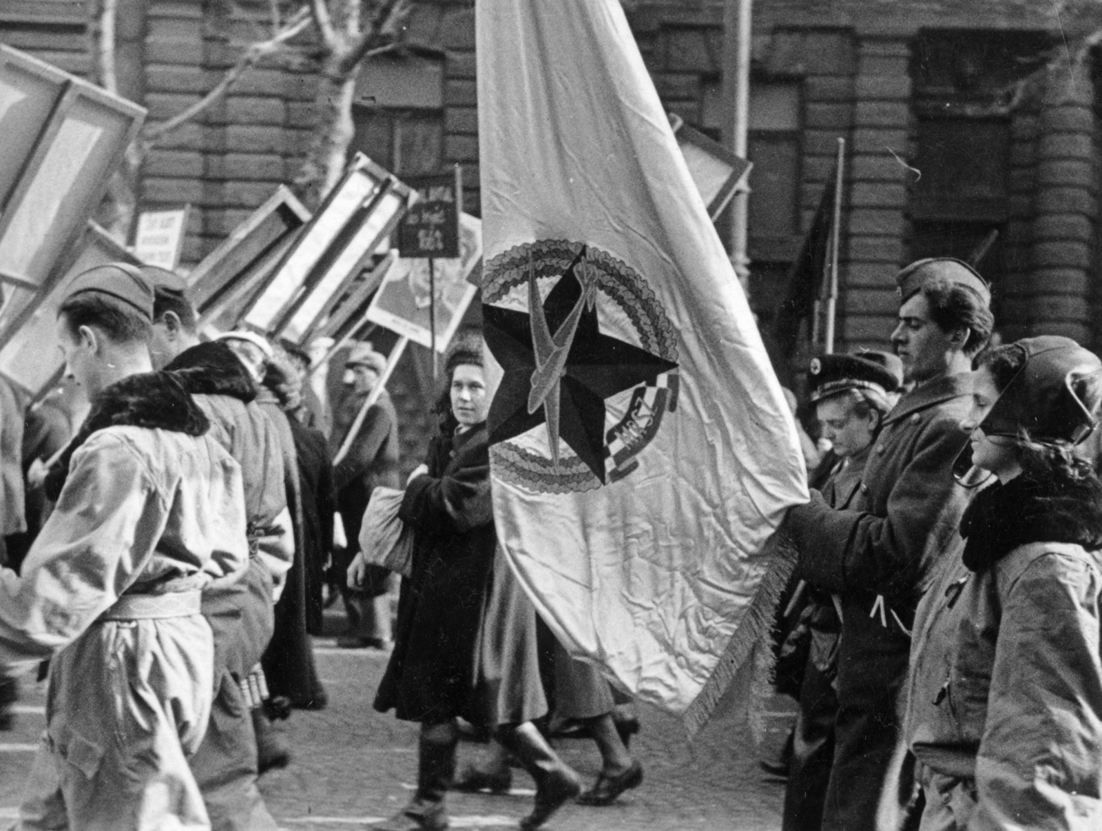 Magyarország, Budapest VI., Andrássy (Sztálin) út, az MDP II. Kongresszusa alkalmából, 1951. február 24-én rendezett felvonulás és nagygyűlés résztvevői. A felvétel a 69-71. szám alatti, Magyar Képzőművészeti Főiskola (később Magyar Képzőművészeti Egyetem) és az Állami Bábszínház épülete előtt készült., 1951, Nasztanovics Ferenc, Budapest, zászló, katona, felvonulás, vörös csillag, Fortepan #222094