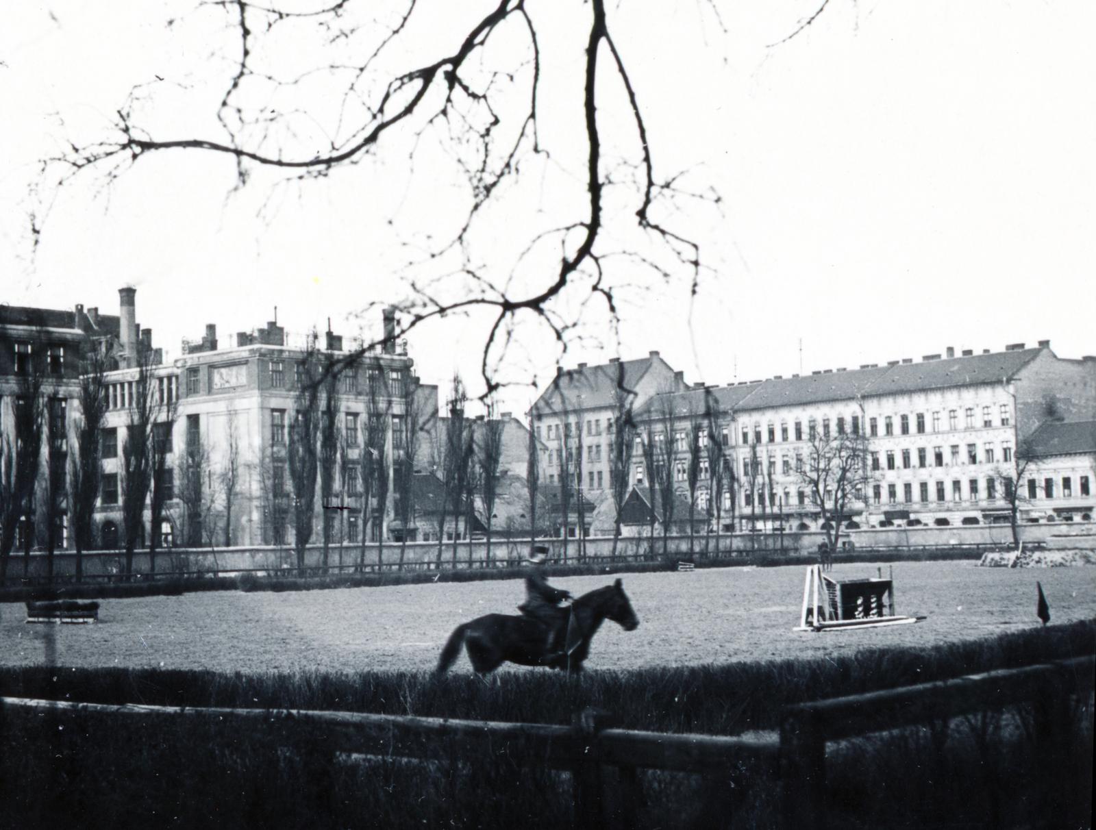 Magyarország, Budapest VIII., Orczy-kert, Ludovika Akadémia. Háttérben balra a Dugonics utcai Általános Iskola (később Kövessi Erzsébet Baptista Szakközépiskola Szakiskola és Gimnázium) Korányi Sándor utcai homlokzata látszik, jobbra a Diószegi Sámuel (Örömvölgy) utca házsora., 1933, Bor Dezső, lovaglás, Budapest, Fortepan #232001