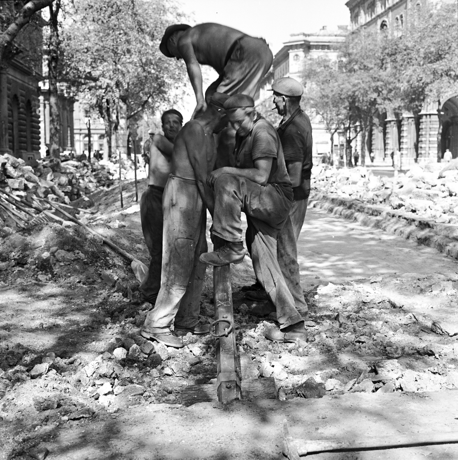 Magyarország, Budapest VI., az Andrássy út (Népköztársaság útja) a Székely Mihály (Kazár) utca és a Dalszínház utca között, a háttérben balra az Operaház, jobbra a Drechsler-palota a Dalszínház utca sarkán. A felvétel az Andrássy út (Népköztársaság útja) Bajcsy-Zsilinszky út és az Oktogon (November 7. tér) közötti szakaszának 1960. nyarán történt átépítése során készült., 1960, FŐMTERV, Domonkos Endre, Budapest, munkás, Fortepan #251335