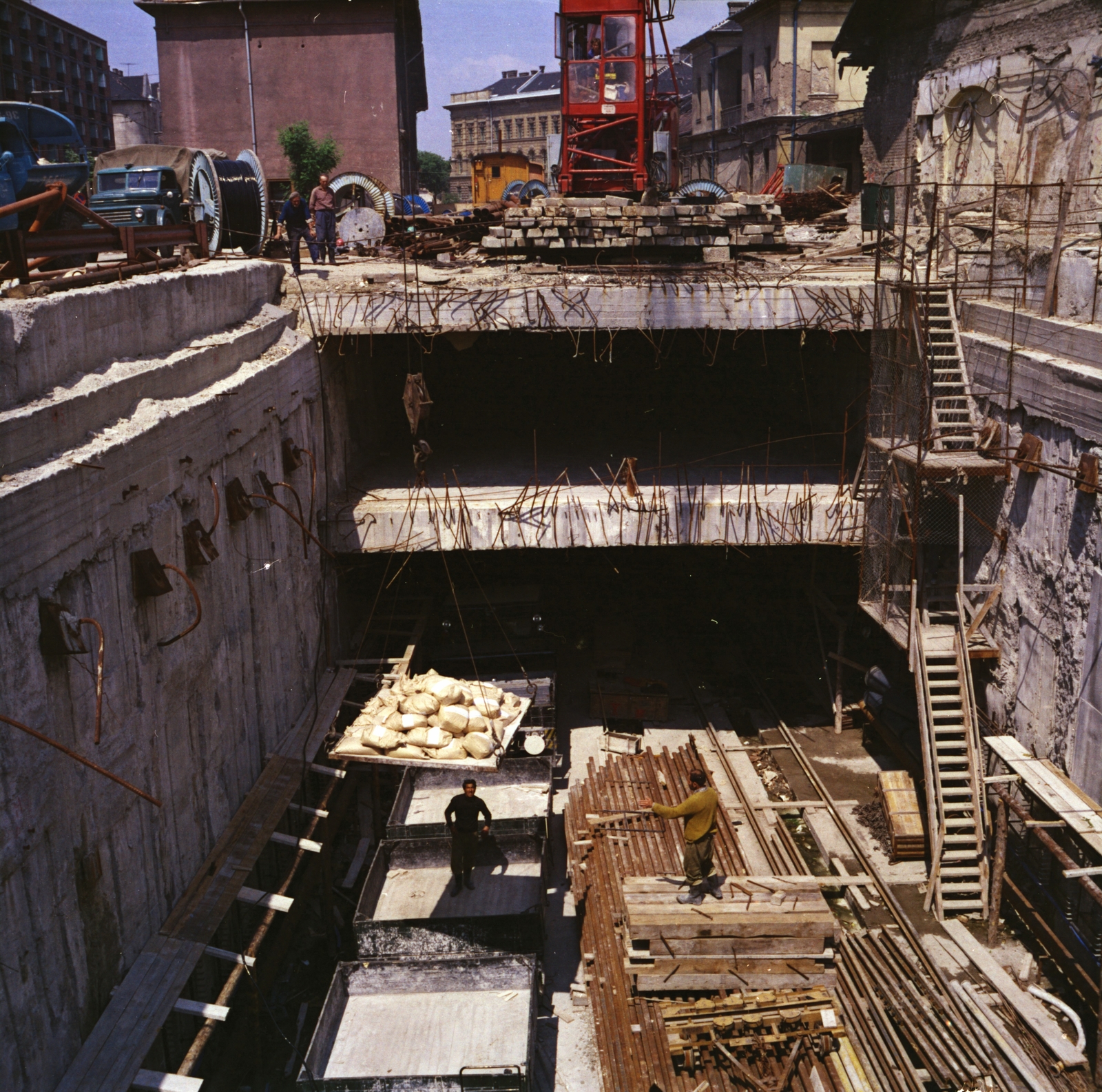 Magyarország, Budapest VIII.,Budapest IX., Üllői út a Nagyvárad térnél, a metró építkezési területe. Háttérben a daru mögött a Ludovika szárnyépülete,, 1976, FŐMTERV, Domonkos Endre, színes, Budapest, Fortepan #253682