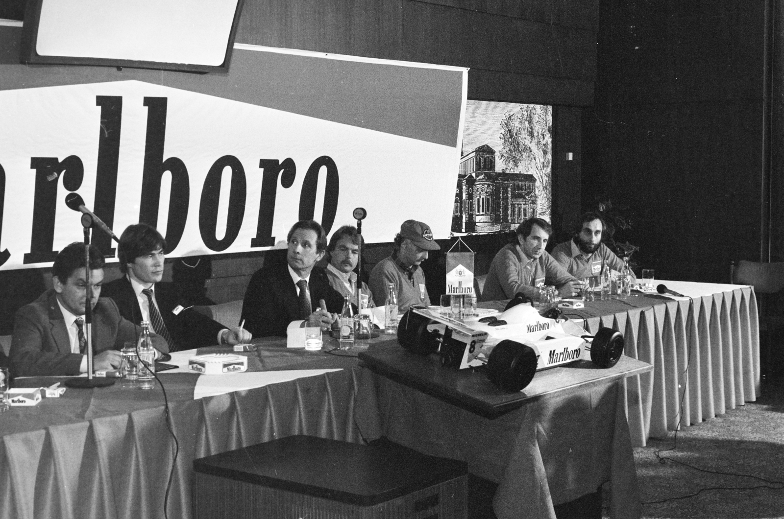 Magyarország, Margitsziget, Budapest, Thermal Hotel, a Marlboro-csapat sajtótájékoztatója. Jobbról Cserkuti József, John Watson, Niki Lauda, Keke Rosberg és a Marlboro-cég motorsport-részlegének vezetője. Bal szélen Domán László az Egri Dohánygyár igazgatója., 1982, Bojár Sándor, Forma-1, Marlboro-márka, autóverseny, Fortepan #255360