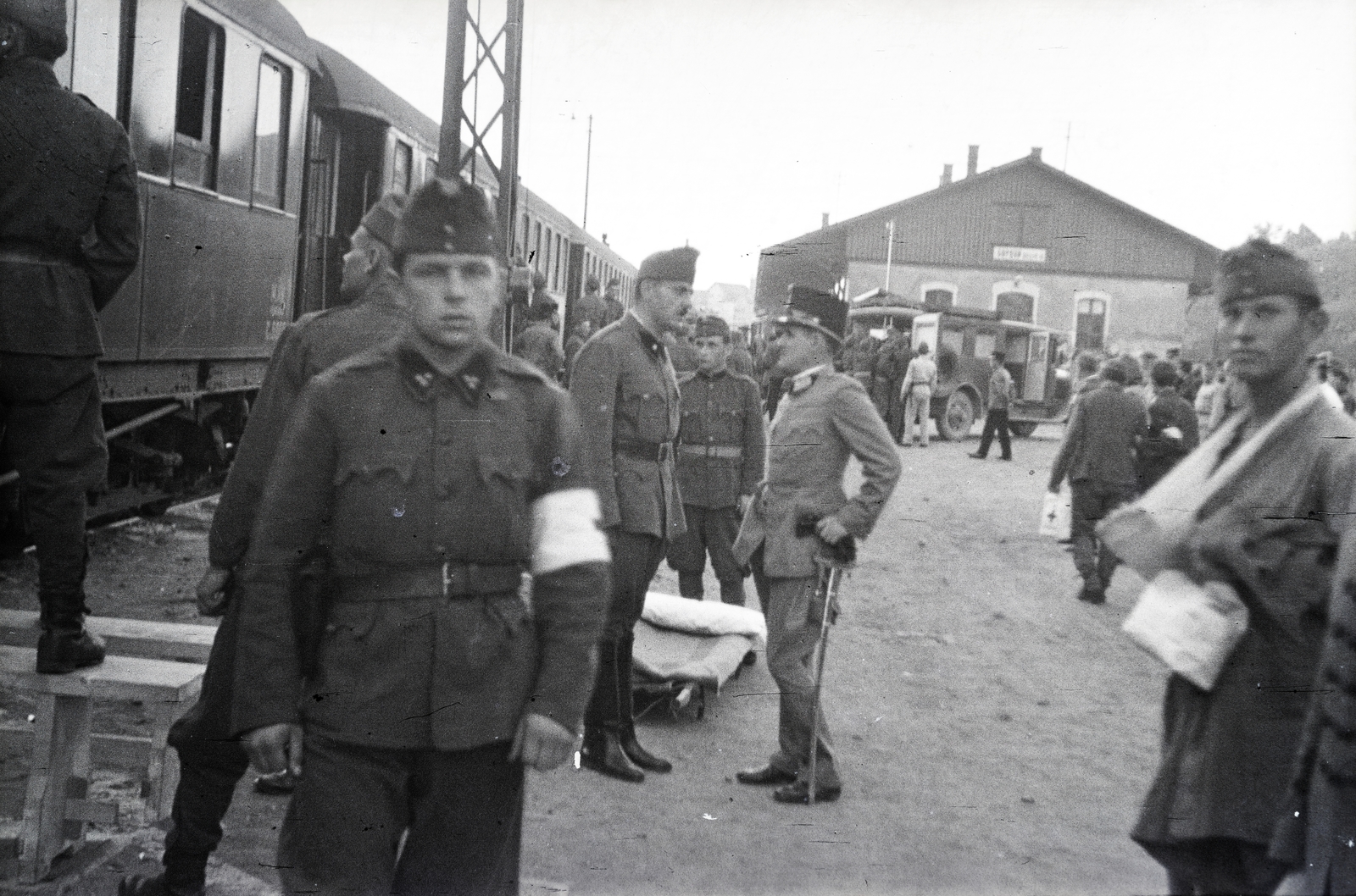 Magyarország, Sopron, Déli pályaudvar, a háttérben mentőautóba emelik át a vöröskeresztes kórházvonatból a hordágyon a sebesült katonát., 1942, Reményi József, Fortepan #258068