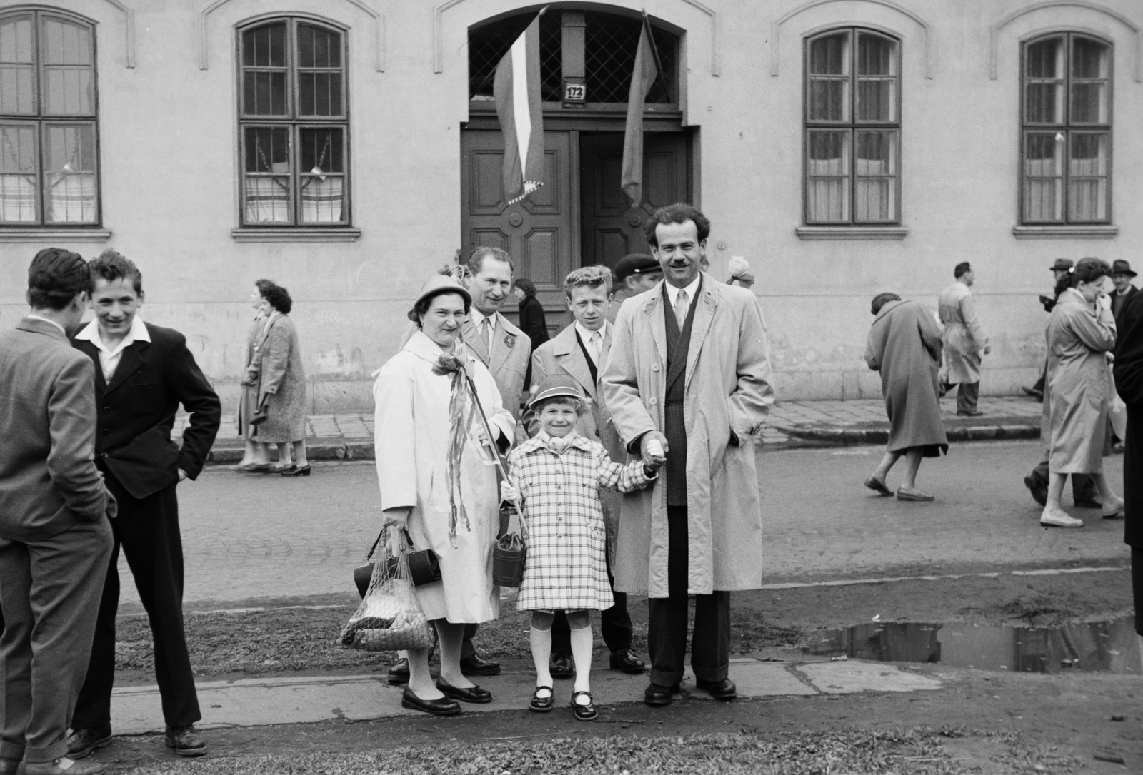 Hungary, Budapest XIV., Hungária körút, május 1- felvonulás résztvevői a 172-es számú épület, a Hermina út 23. alatti Általános Iskola előtt., 1955, Reményi József, flag, family, trench coat, string bag, maypole, Budapest, Fortepan #258745