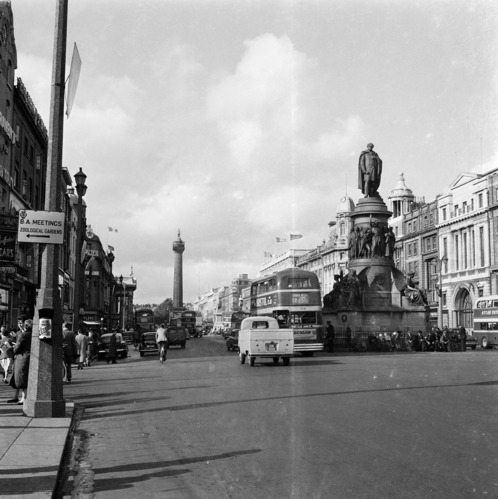 O'Connell Street, jobbra a Daniel O'Connell emlékmű (John Henry Foley, 1882.), háttérben a Nelson-emlékoszlop., 1956, UWM Libraries, street view, English sign, photo aspect ratio: square, bicycle, bus, sculpture, Fortepan #258841