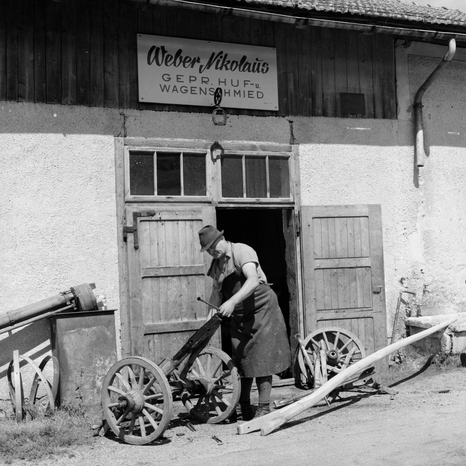 Austria, bognárműhely., 1956, UWM Libraries, photo aspect ratio: square, german text, apron, wheel, Fortepan #258943