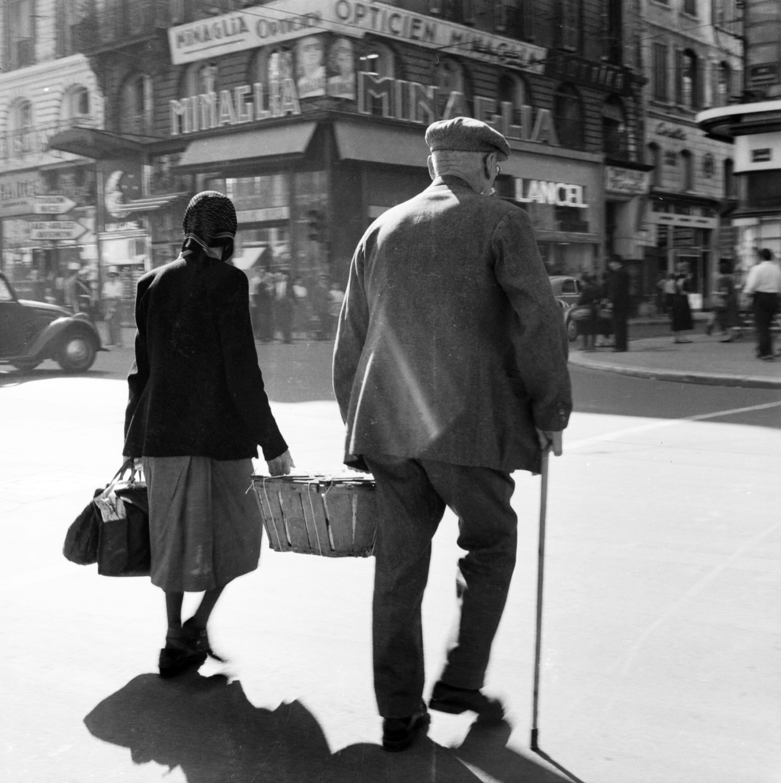 France, Marseille, La Canebière 30., a Rue Saint-Ferréol sarkán., 1958, UWM Libraries, Best of, photo aspect ratio: square, ad, carrying, back, man and woman, Fortepan #259529