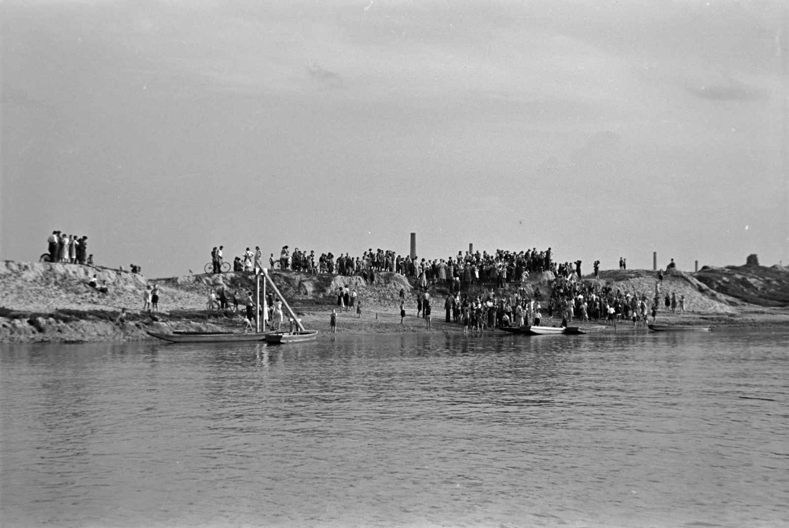 Hungary, Győr, Mosoni-Duna, a parton az evezősverseny nézőközönsége. A csónakokon a faszerkezet a célvonalat jelzi., 1937, Nagy István, boat, shore, Fortepan #264115