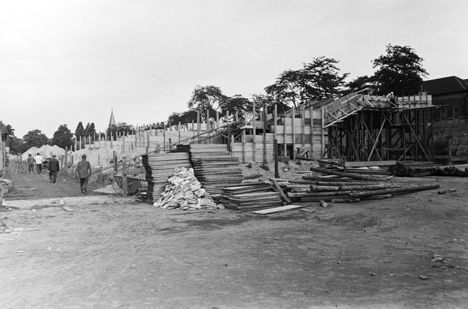 Hungary, Budapest IX., Üllői út, FTC pálya, a stadion építkezése. Balra a Nagyvárad téri református templom tornya, jobb szélen Állami Pénzverő épületének részlete látható., 1971, Középületépítő Vállalat - Kreszán Albert - Koczka András - Kemecsei József, Budapest, Fortepan #269537