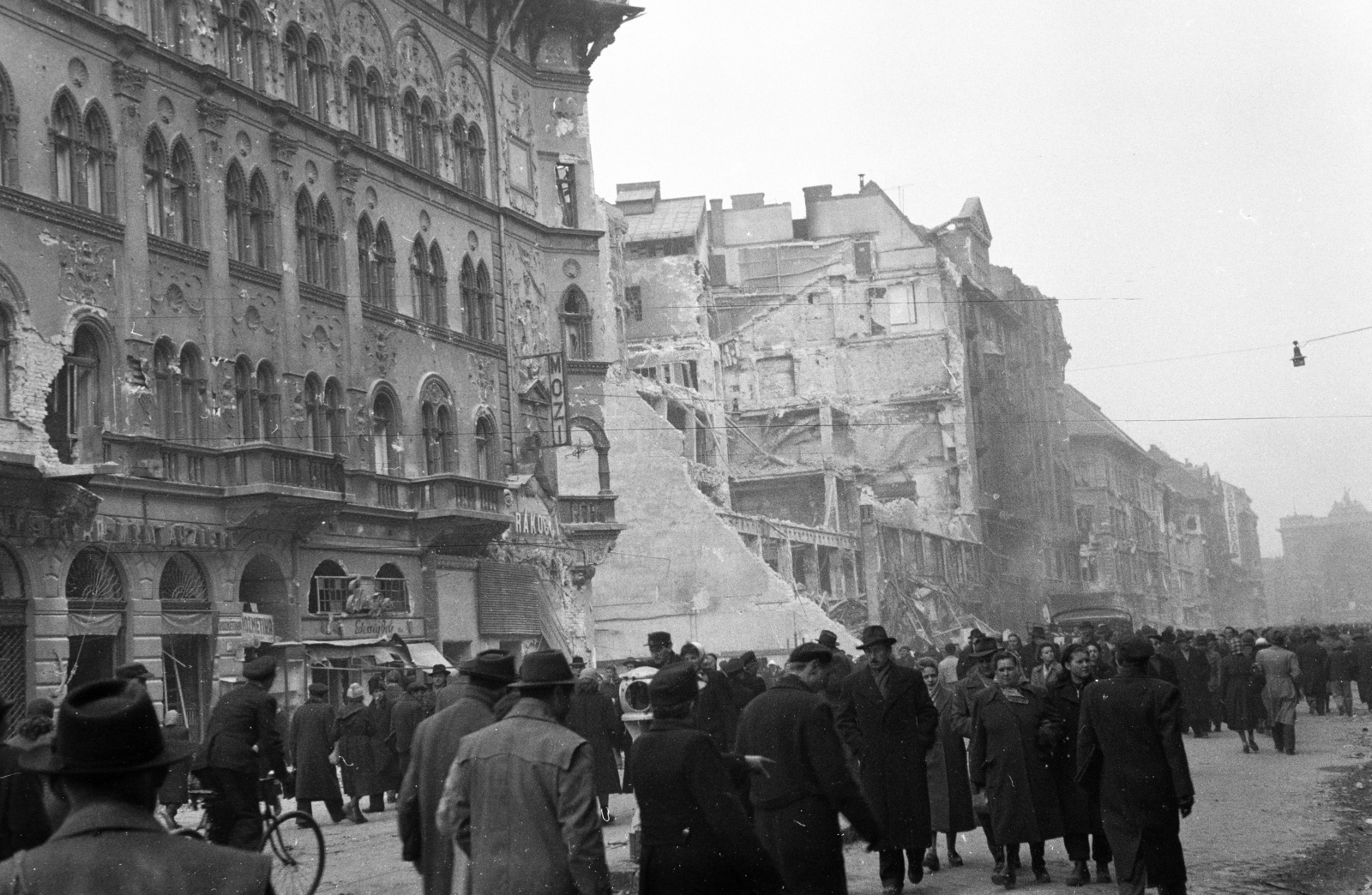 Magyarország, Budapest VII.,Budapest VIII., Rákóczi út a Keleti pályaudvar felé nézve, szemben a Magyar Divatcsarnok romjai., 1956, Papp Dezső, járókelő, épületkár, Budapest, kerékpár, Fortepan #272741