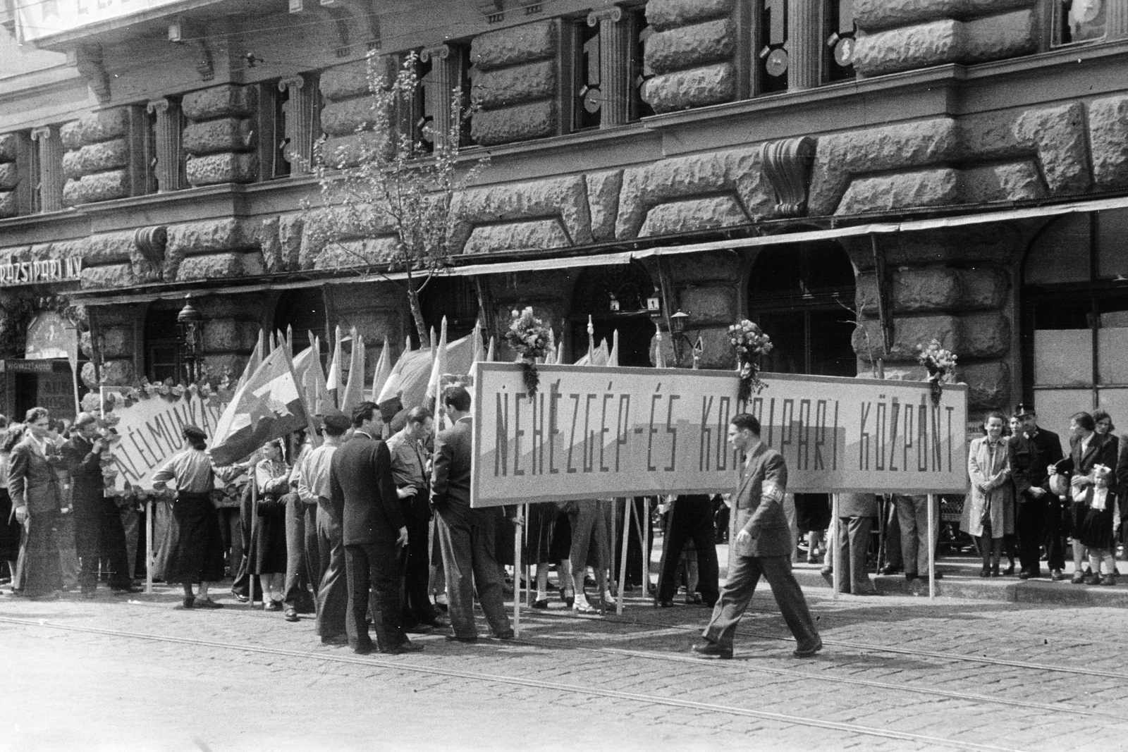 Magyarország, Budapest V., felvonulók a Vértanúk terén. A felvétel a Kossuth Lajos tér sarkán álló ház előtt készült., 1950, Kern család, Budapest, felvonulás, karszalag, transzparens, zászló, Fortepan #273327