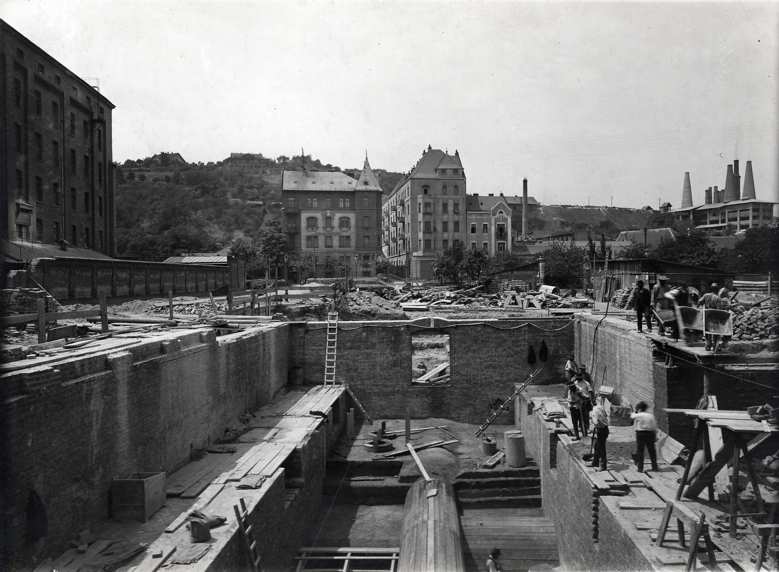 Hungary, Budapest II., Zsigmond tér, Óbuda új főgyűjtőcsatornájának és szivattyútelepének építése, balra az Első gőzmalom részvénytársaság épülete. Háttérben balra a Frankel Leó út (Zsigmond utca) - Darázs utca sarkánál a Magyar Királyi Állami Főgimnázium épülete látható., 1913, Molnár Gyula, Budapest, Fortepan #274574