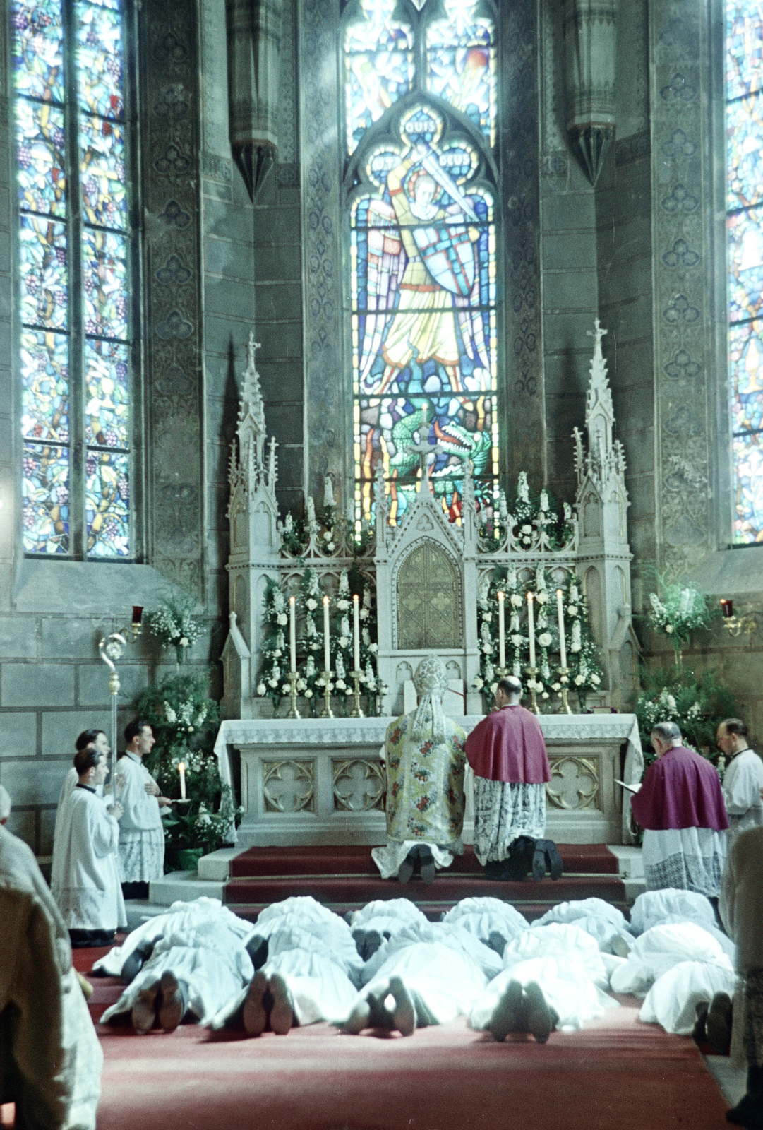 Hungary, Veszprém, Szent Mihály-székesegyház, az imazsámolynál Badalik Bertalan veszprémi püspök. A felvétel a végzett teológusok papszentelésekor készült., 1956, Hámori Gyula, colorful, church interior, bishop, ritual, shepherd's crook, lying on stomach, altar, leaded glass, Fortepan #276212