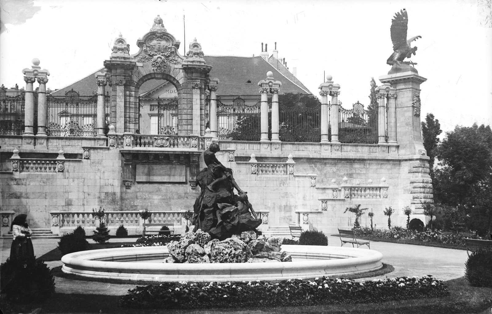 Magyarország, budai Vár, Budapest I., Királyi Palota (később Budavári Palota), Várkert, balra a Halászó gyerekek-díszkút (Senyei Károly, 1900). Feljebb a kert kapuja mögött a Szent György téren a Sándor-palota. Jobbra Donáth Gyula Turul szobra (1905)., 1905, Deutsche Fotothek / Brück und Sohn, szobor, díszkút, kovácsoltvas kerítés, Budapest, Fortepan #277762