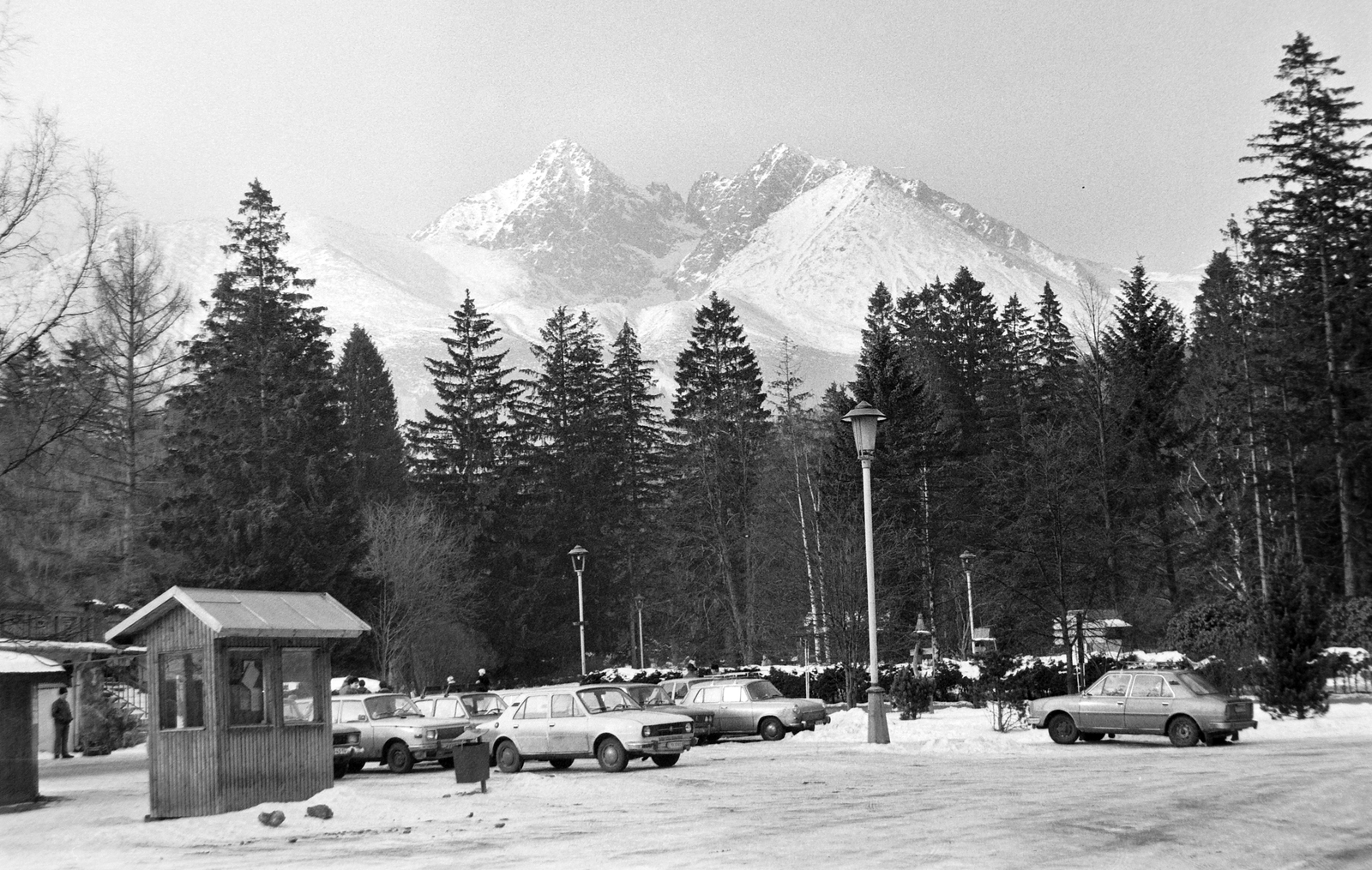 Slovakia,High Tatras, Tatranská Lomnicá, a sífelvonó közelében. A háttérben (balról jobbra) a Lomnici, a Késmárki és a Hunfalvi csúcs., 1981, Németh Tamás, Czechoslovakia, woods, winter, Czechoslovak brand, German brand, Soviet brand, Skoda-brand, Moskvitch-brand, Wartburg-brand, car park, lamp post, automobile, Tatra Mountains, Fortepan #30179