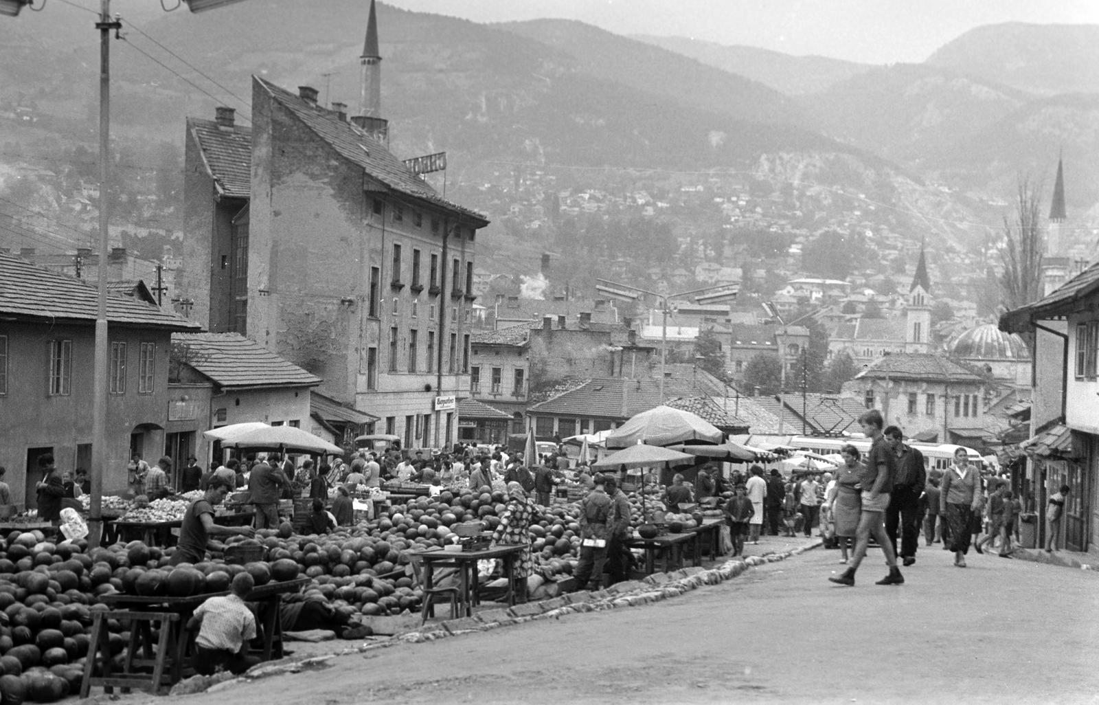 Bosznia-Hercegovina, Szarajevó, Baščaršija. Háttérben balra a Császármecset / Careva džamija (más néven Džamija sultana Mehmeda II. Fatiha / II. Fatih Mehmed szultán mecsete). Jobbra a Páduai Szent Antal-templom / Crkva svetog Ante Padovanskog és a Havadze Duraka dzsámi minaretje., 1960, Gazda Anikó, piac, völgy, dinnye, Fortepan #308530