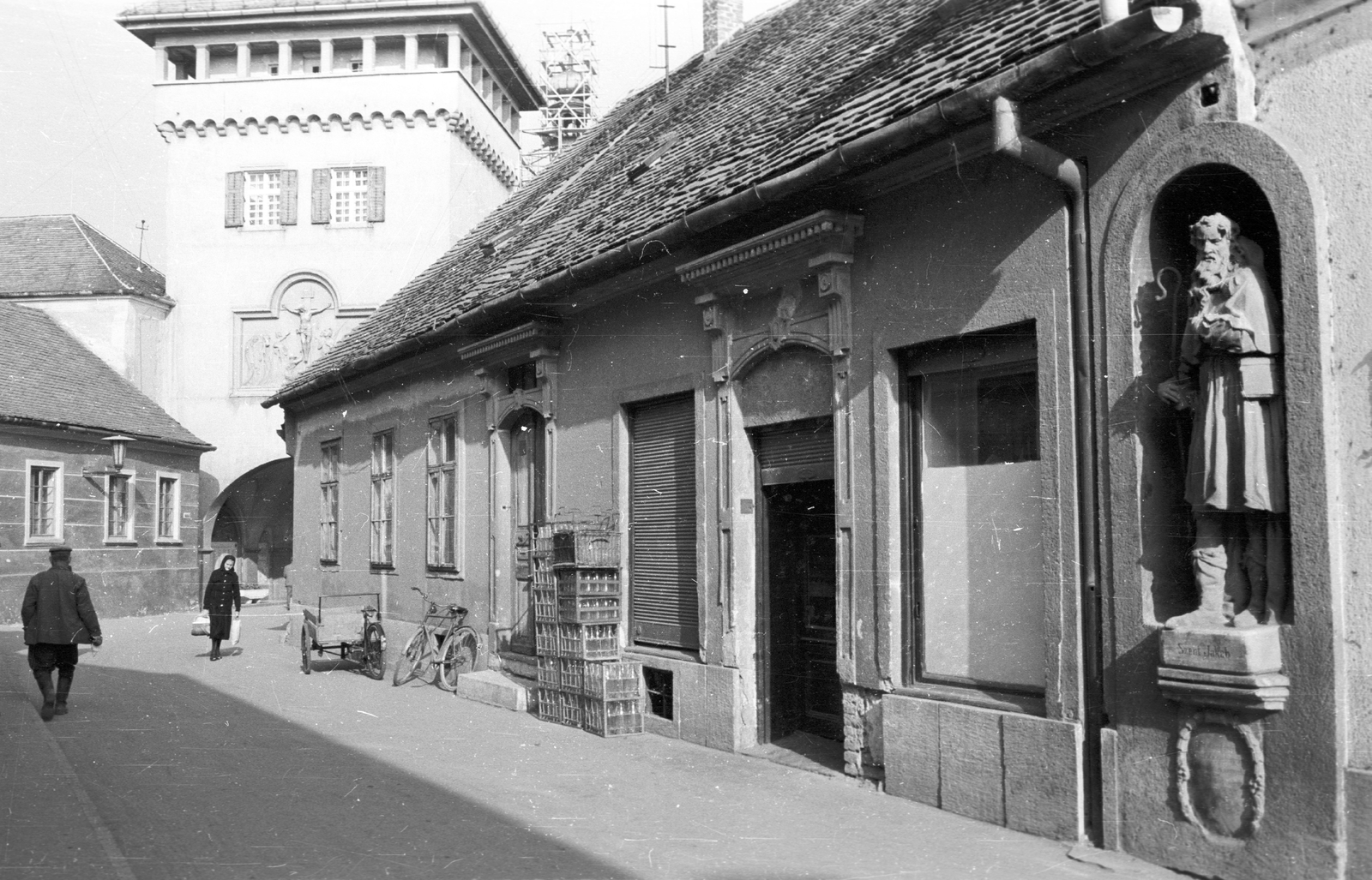 Hungary, Kőszeg, Városház utca, jobbra a 3-as számú ház Szent Jakab szobrával (az "1729-ből származó szobor eredetileg a város alsókapujának hídfőjén állott"). Szemben a Hősök kapuja., 1965, Építésügyi Dokumentációs és Információs Központ, VÁTI, tricycle, crate, architectural ornament, statue, bicycle, Fortepan #32261