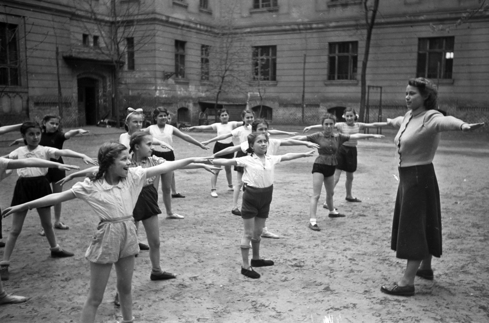 Hungary, Budapest XIII., Tutaj utca 7-11., a Budapest Székesfõváros Községi Általános Fiúiskola és Budapest Székesfőváros Pannónia utcai Általános Leányiskola közös udvara (később Pannónia Általános Iskola)., 1949, Kovács Márton Ernő, school, exercise, Budapest, spreading, spread out arms, Fortepan #32835