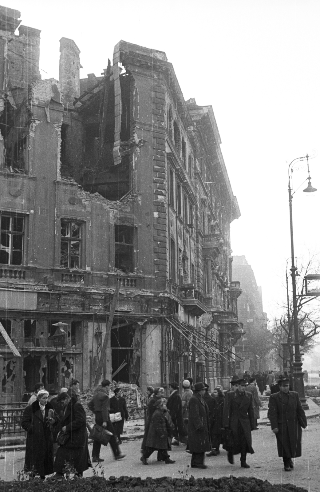 Magyarország, Budapest VI., Oktogon (November 7. tér) - Andrássy (Sztálin) út sarok, Abbázia kávéház., 1956, Nagy Gyula, háborús kár, forradalom, járókelő, utcakép, életkép, rom, lámpaoszlop, Budapest, épületkár, Fortepan #40218