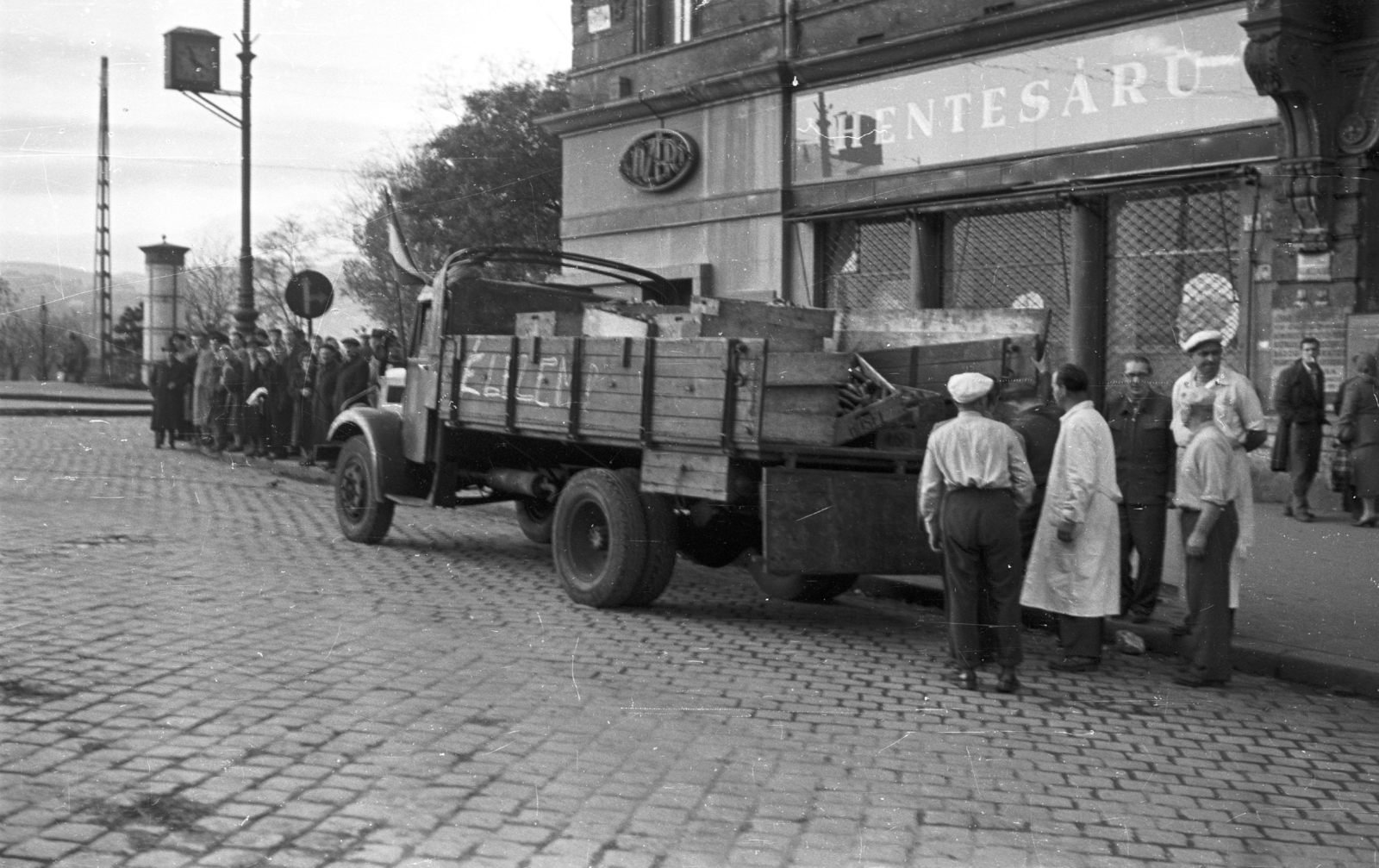 Magyarország, Budapest XIII., Szent István körút - Jászai Mari tér sarok., 1956, Nagy Gyula, zászló, cégtábla, felirat, forradalom, magyar gyártmány, teherautó, Csepel-márka, hentesüzlet, Budapest, élelmiszerbolt, Közért Vállalat, Fortepan #40239