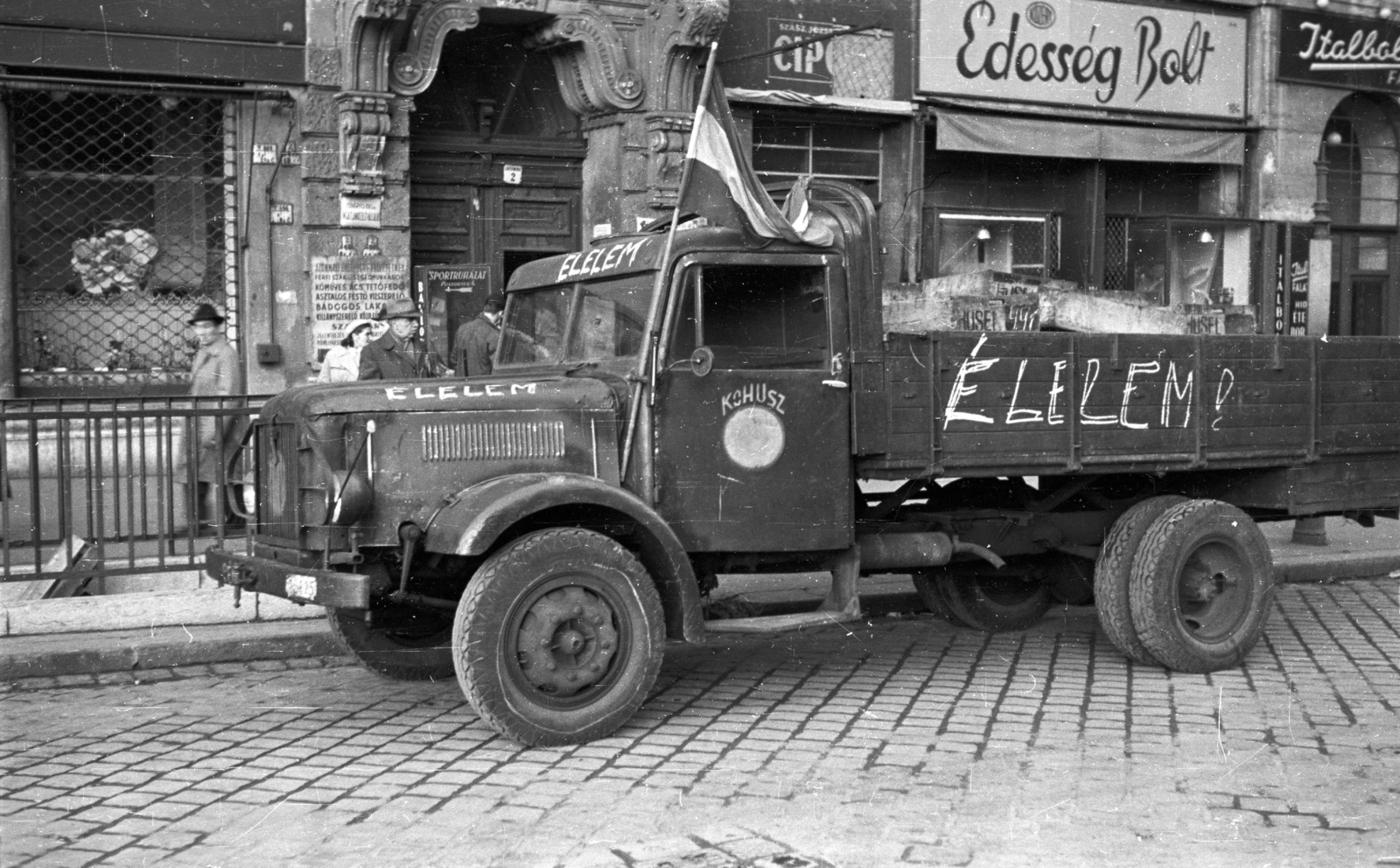 Hungary, Budapest XIII., Szent István körút, a forradalom alatt, a Konzerv és Húsipari Szállítási Vállalattól átvett, élelmiszert szállító Csepel teherautó a 2-es számú ház előtt., 1956, Nagy Gyula, flag, sign-board, label, revolution, Hungarian brand, grocery store, commercial vehicle, Csepel-brand, candy store, Budapest, Tinned- And Met Industry Transportation Co., Fortepan #40240