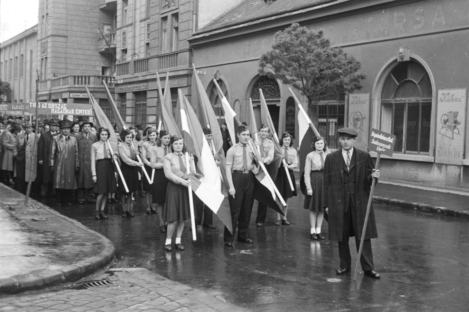 Hungary, Győr, Árpád út a Teleki László utca sarokról fényképezve, szemben a Árpád út 51/a és 51/b. Május 1-i felvonulás résztvevői., 1947, Konok Tamás id, uniform, flag, street view, 1st of May parade, pioneer, Fortepan #43241