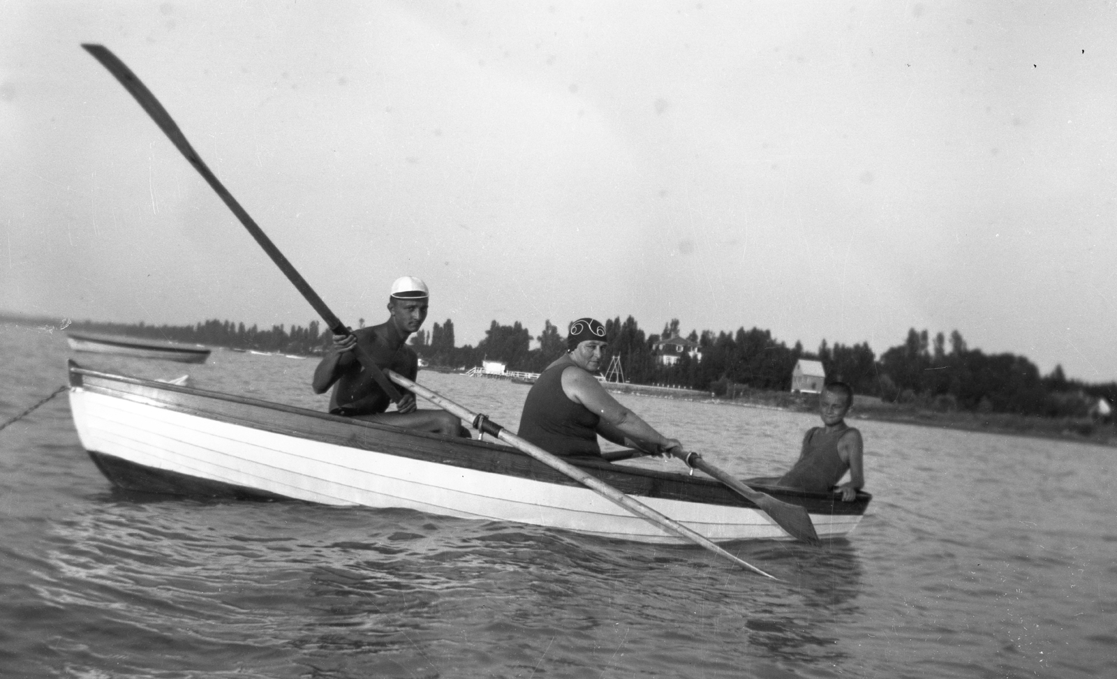 Hungary,Lake Balaton, Siófok, Szabadifürdő (ekkor Balatonszabadi település része)., 1934, Korenchy László, bathing suit, tableau, men, water surface, summer, boat, bathing caps, woman, paddling, shore, paddle, Fortepan #44515