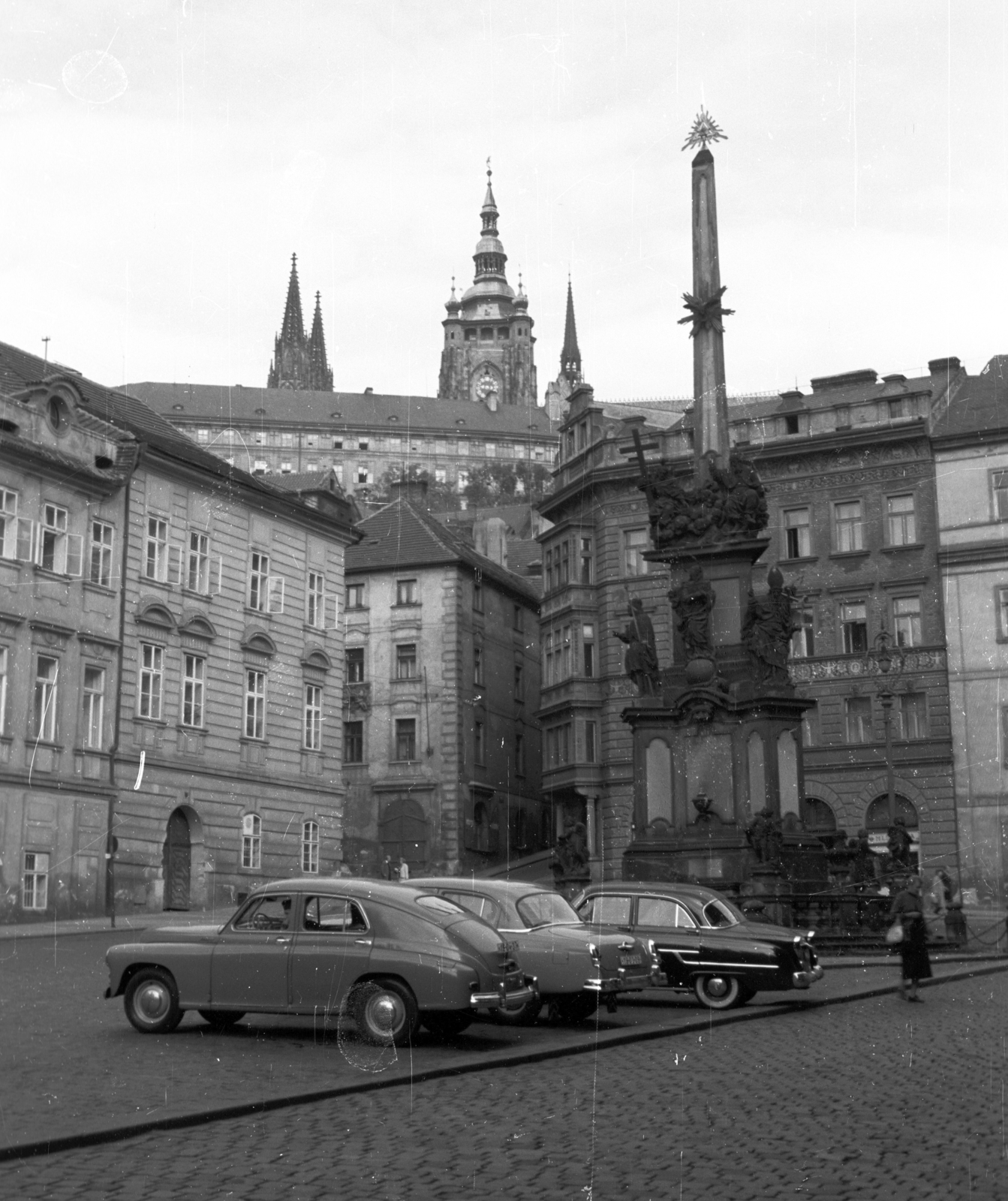 Czech Republik, Prague, Kisoldal tér (Malostranské námesti)., 1959, Nagy Gyula, Czechoslovakia, street view, palace, cobblestones, gothic, Classicism, Obelisk, automobile, Holy Trinity Statue, symbol, Cathedral, Saint Wenceslas-portrayal, Saint John of Nepomuk-portrayal, Virgin Mary-portrayal, Peter Parler-design, Jan Oldřich Mayer-design, Giovanni Battista Alliprandi-design, Matthias of Arras-design, Ferdinand Geiger-design, Ignaz Franz Platzer-design, Eye of Providence, Saint Adalbert of Prague-portrayal, Saint Procopius of Sázava-portrayal, Saint Ludmila-portrayal, Mathias Hummel-design, Fortepan #51335