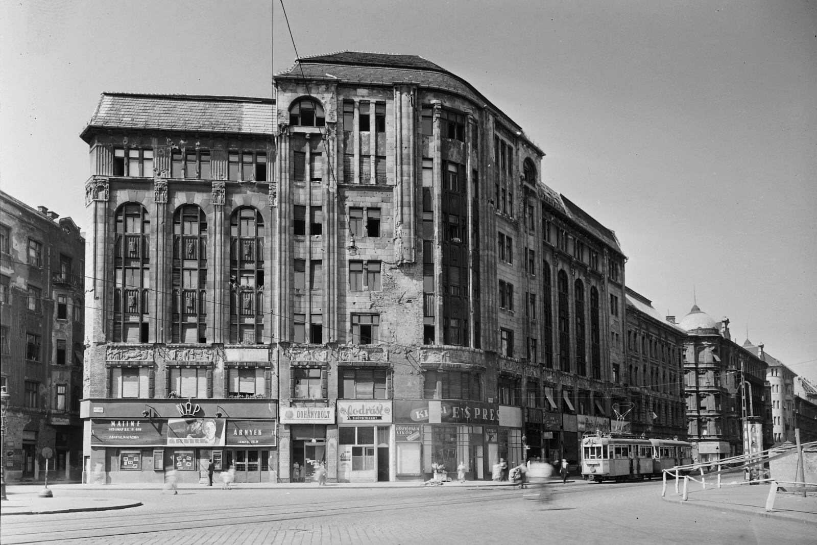 Hungary, Budapest VIII., Népszínház utca - Nagy Fuvaros utca sarok, Nap mozi., 1957, UVATERV, sign-board, espresso, tram, tobacco shop, store display, hairdresser, damaged building, movie theater, Budapest, Fortepan #5319